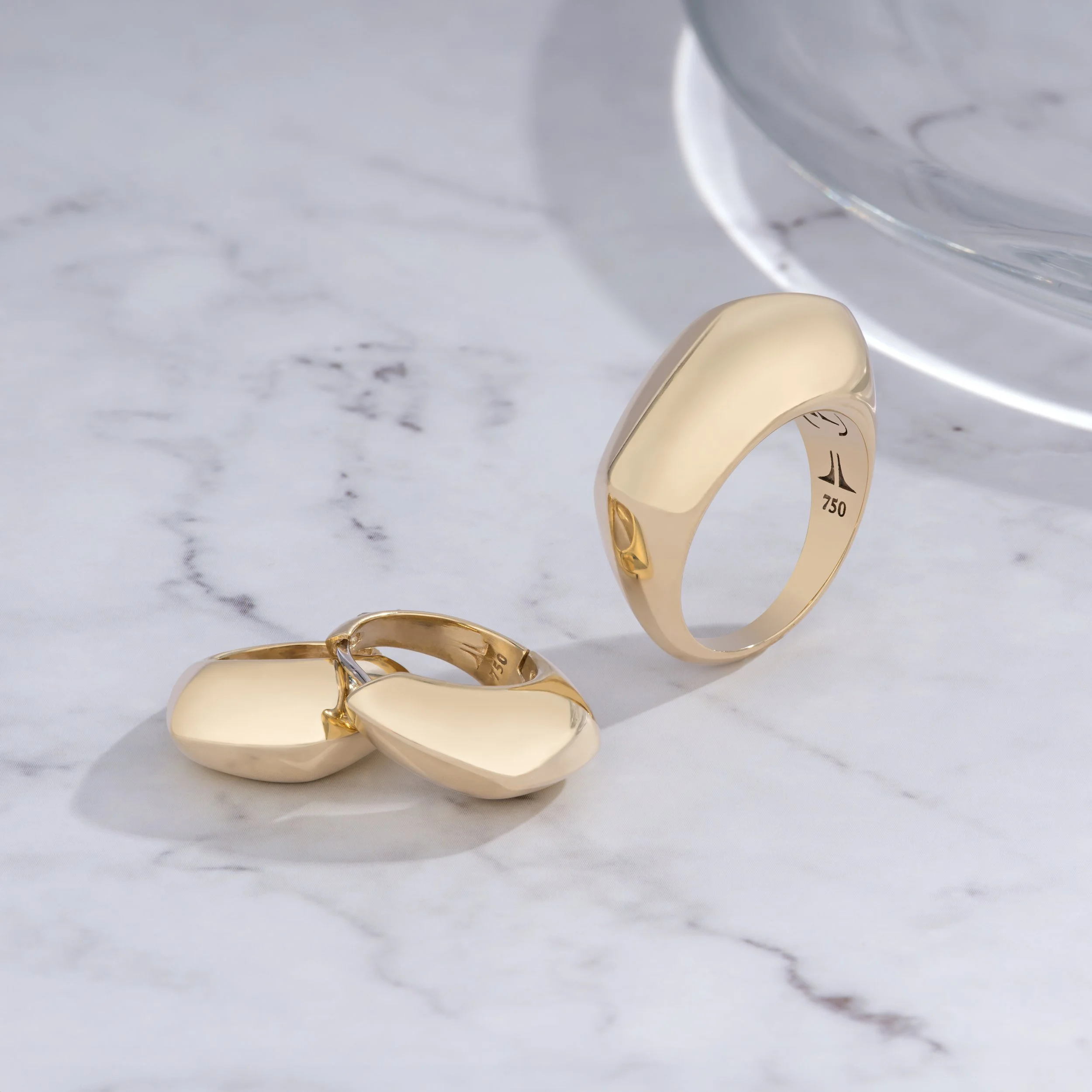 Close-up of a gold bola rings by House of Lif