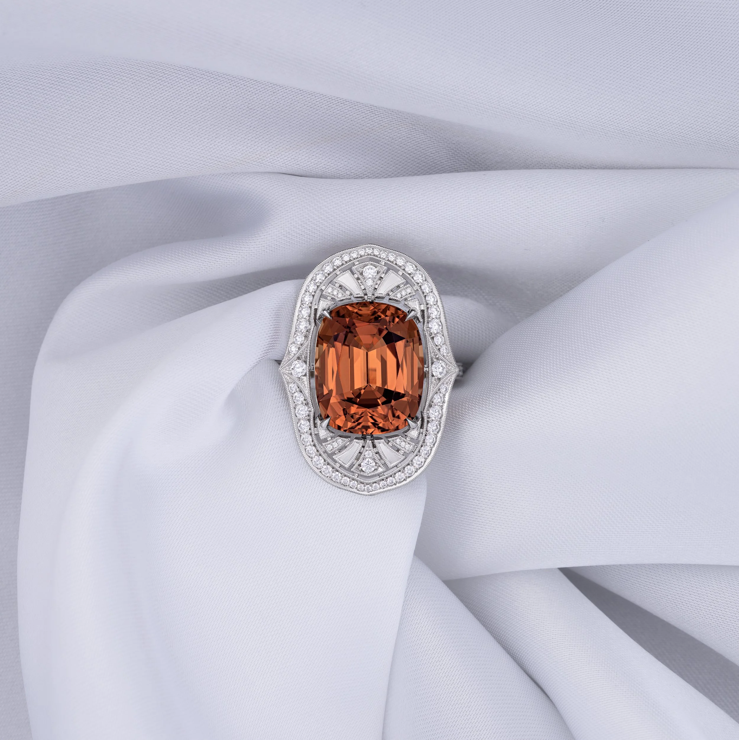 Orange garnet ring with diamond accents. 