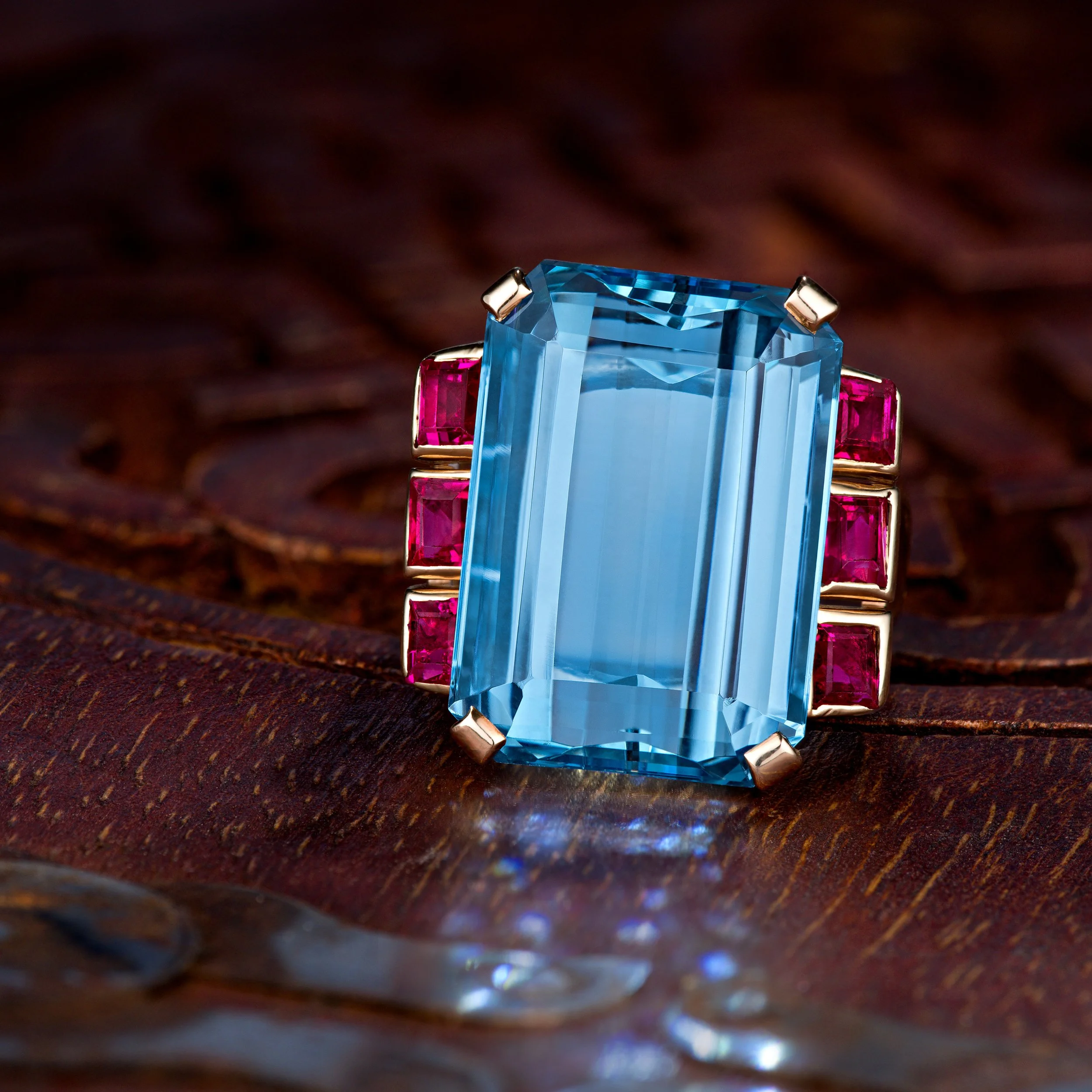 Retro Aquamarine Emerald Cut center stone and Ruby side stone ring.