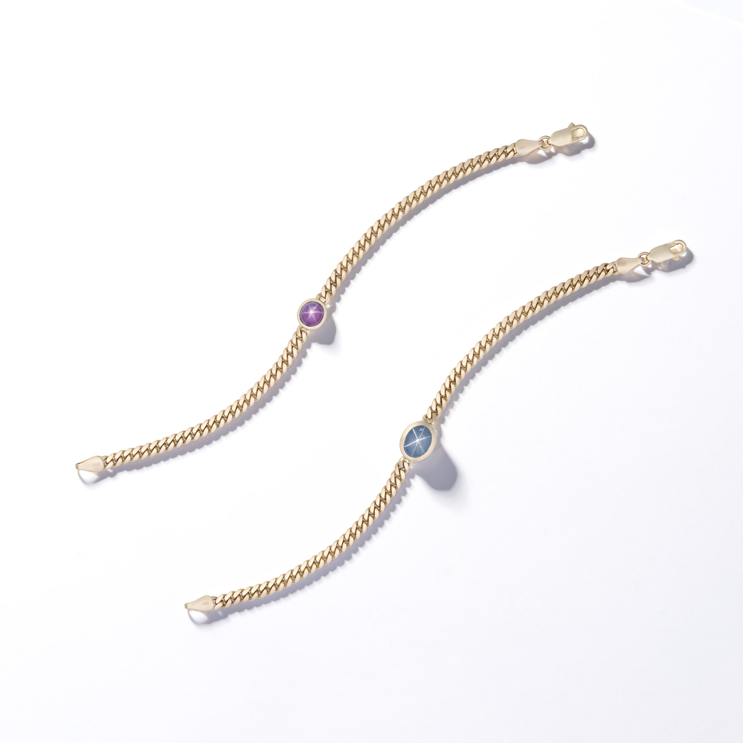 Two gold chain bracelets with Star ruby and Star sapphire gemstones