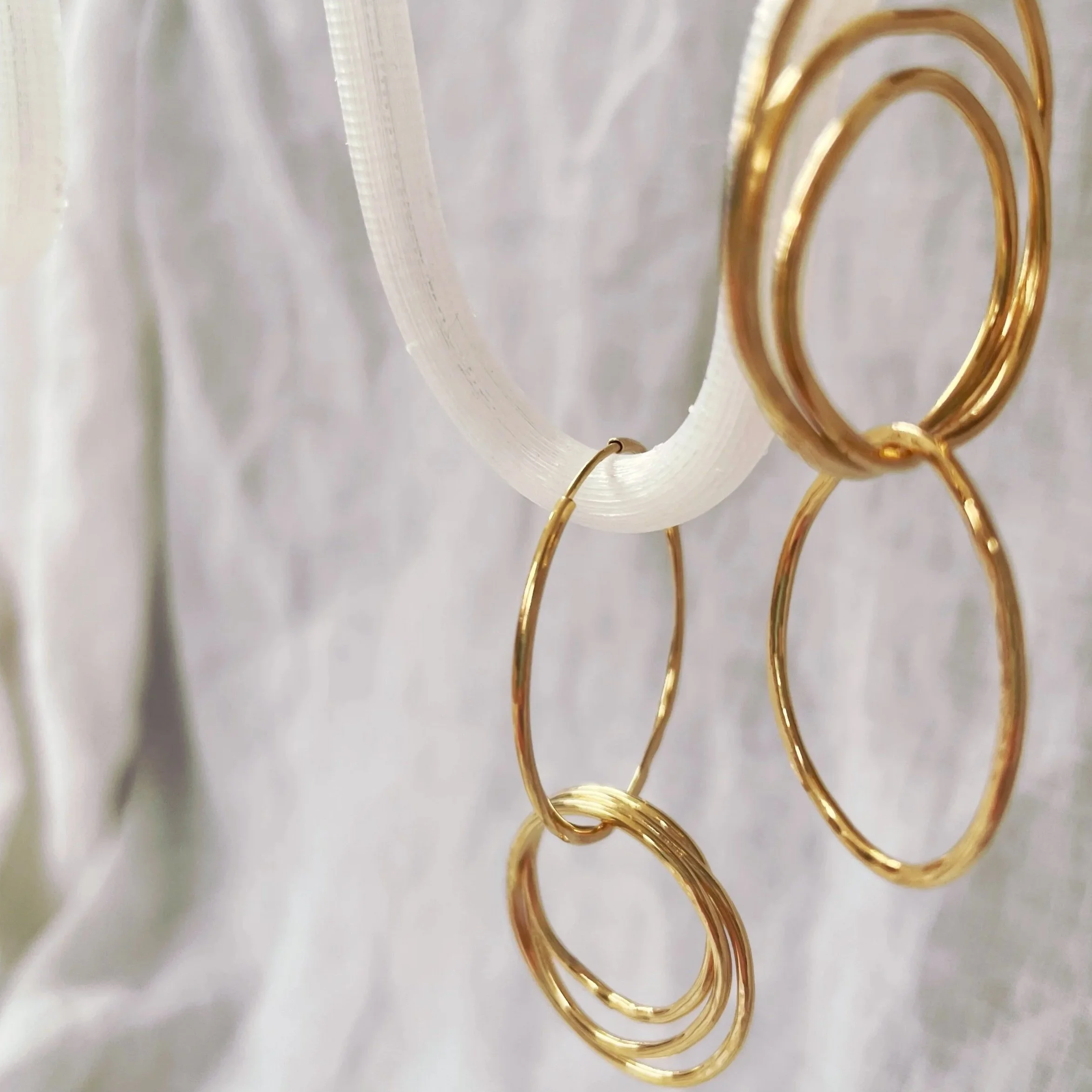 Asymmetric knot drop hoops