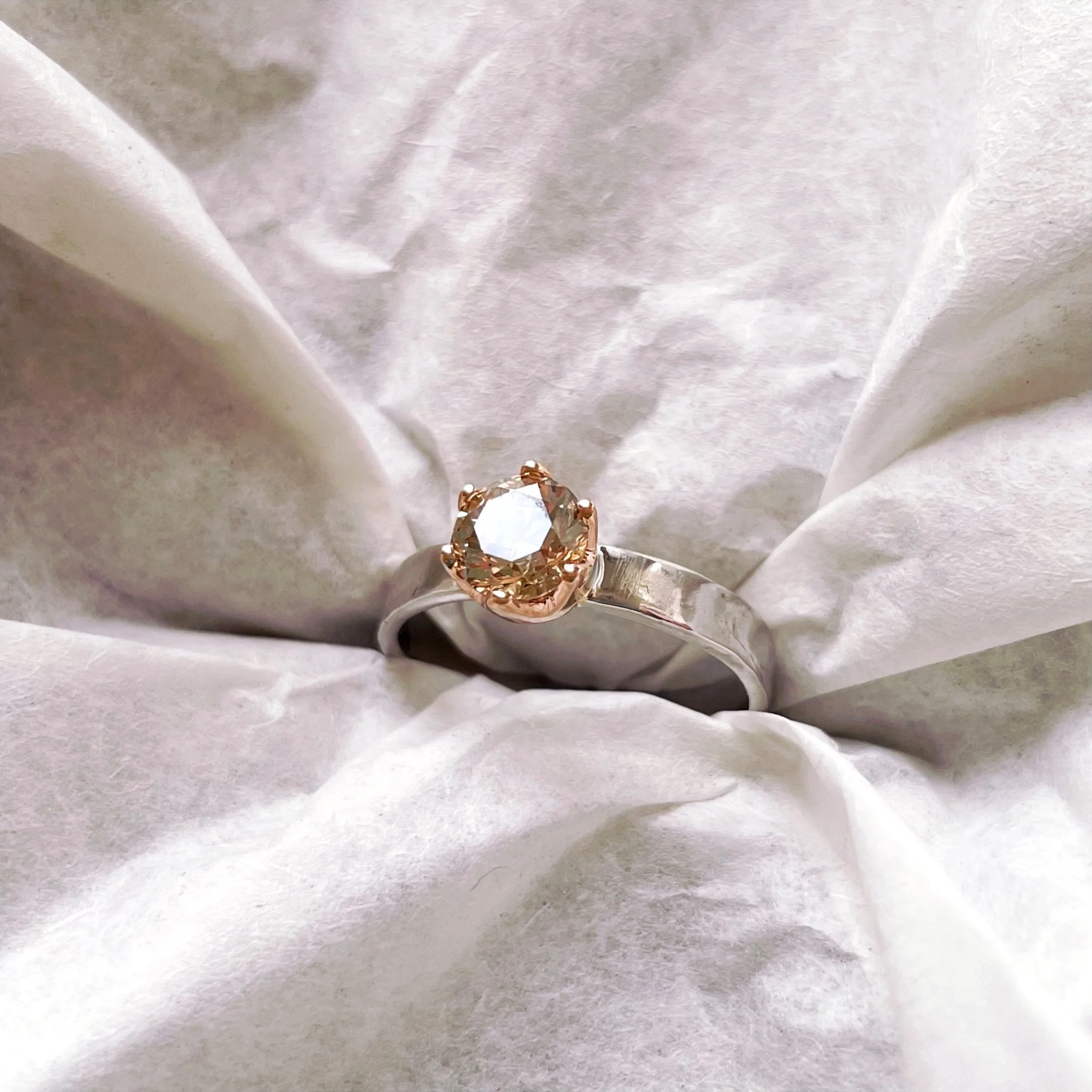 Heirloom gold reworked into engagement ring with family champagne diamond