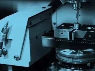 A close-up of a high-precision diamond milling tool machining an insert of an injection moulding tool used in IVD products.