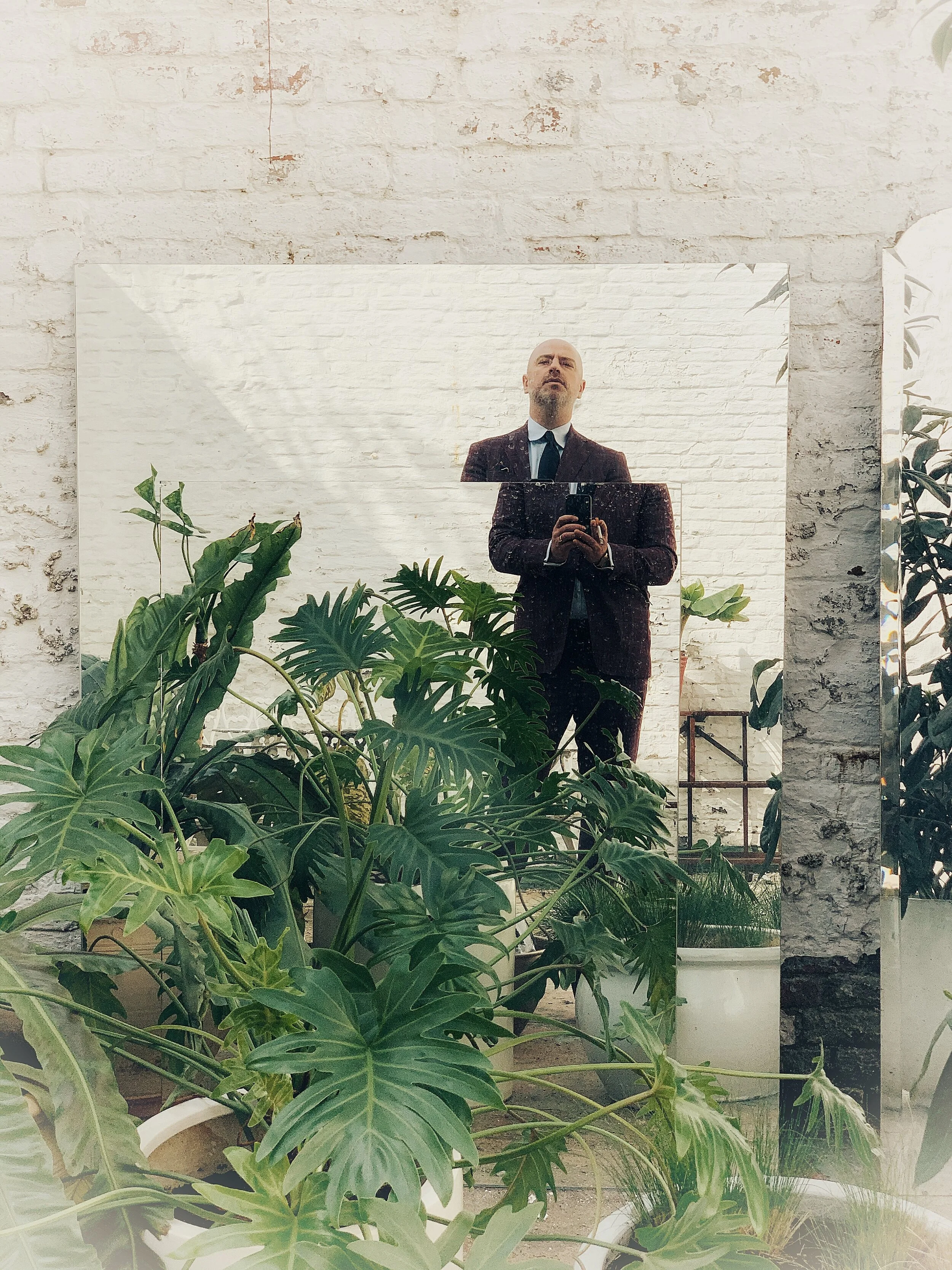 Bright natural dining room nook with vases plates and fruits on the table.
