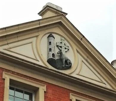 Pediment containing three symbols of Ireland: a round tower, a Celtic high cross and an Irish wolfhound