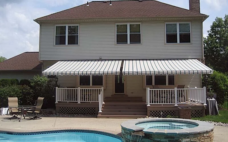 Retractable awnings cover a porch for outside living.