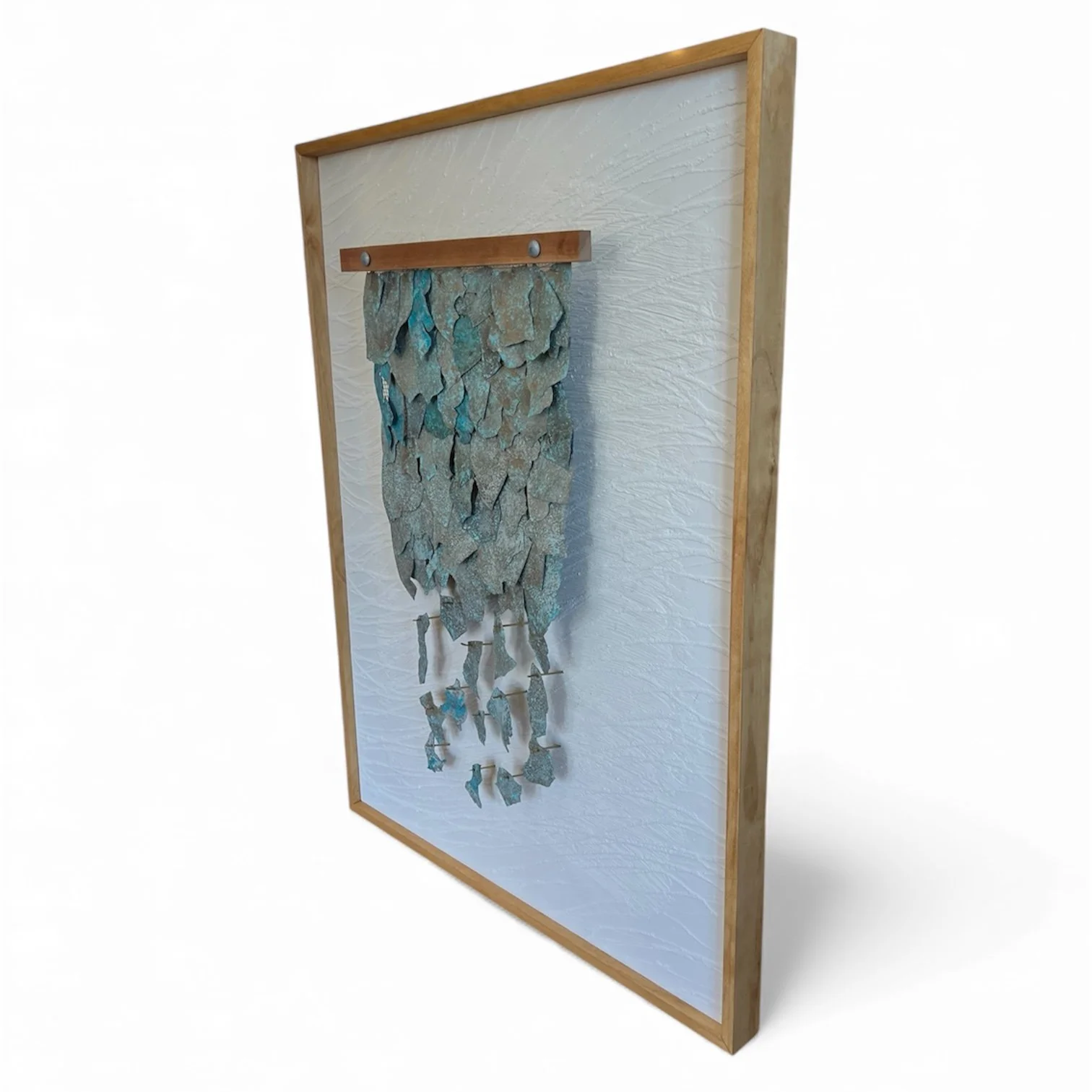 Notice the depth. Cymbal fragments cascade downward, each one hovering just off the sandy backboard, allowing light and shadow to give the piece its sense of flow.