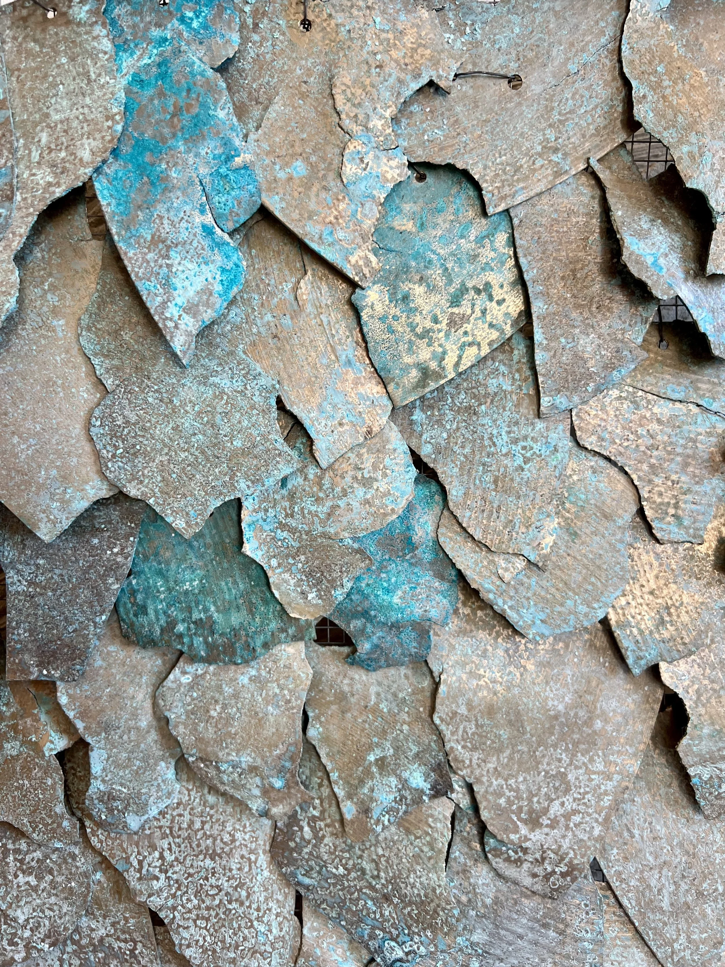 Each cymbal fragment has been patinated so that, over time, its surface will continue to shift—deepening into more aquatic hues as the piece ages.