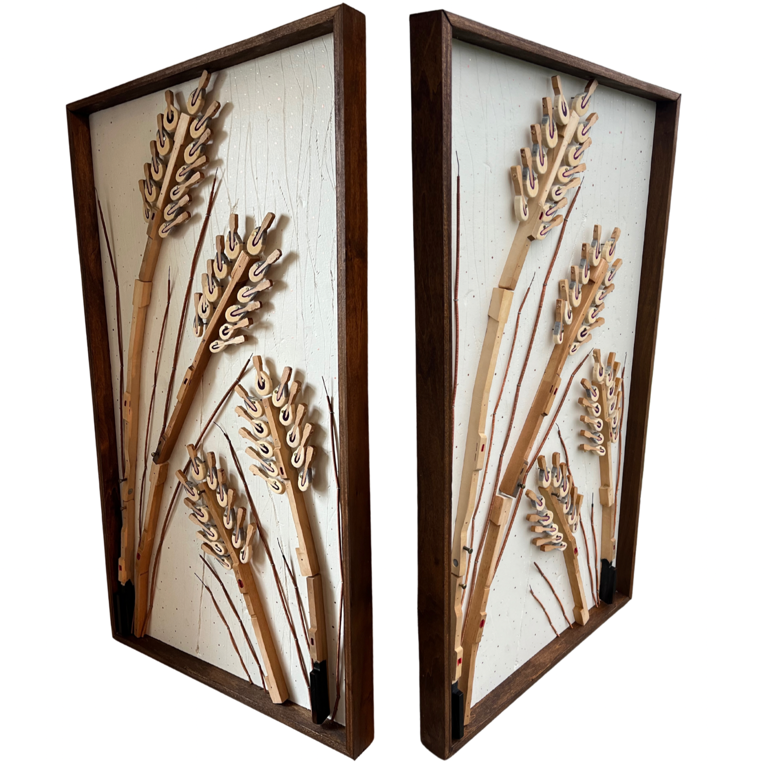 Mixed media art piece featuring wooden and metal piano wire depictions of wheat stalks with seed heads, framed in wood.