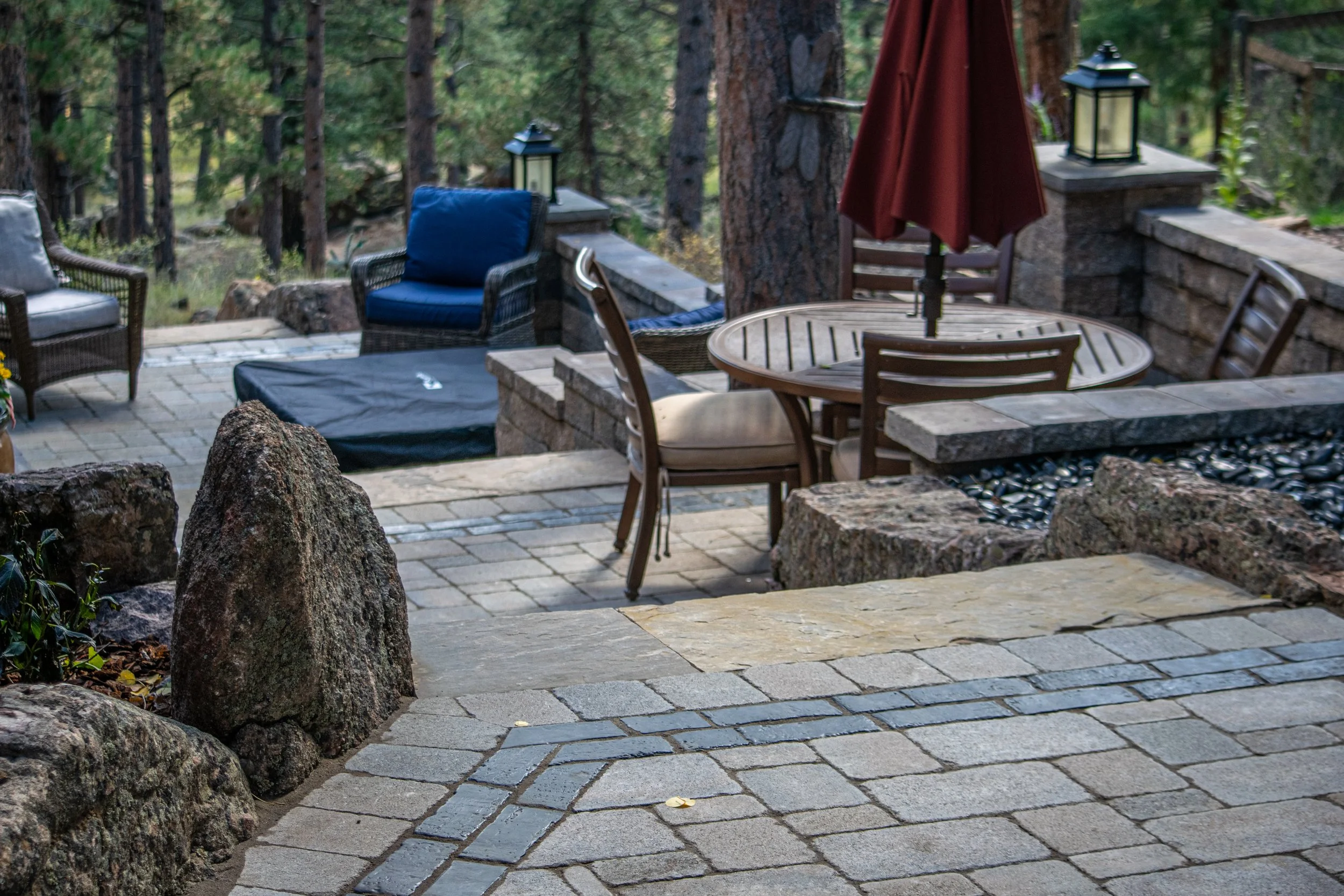 Outdoor living space and entertainment area with paver patios, fire pit, outdoor kitchen in Evergreen, CO
