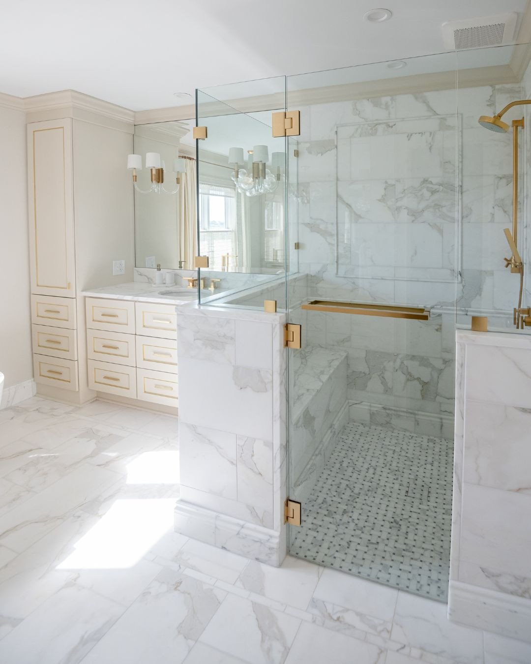 This master bath transformation was too good not to share. The shower features custom marble with elegant pencil trim details, and we even carried the marble onto the trim and baseboards for a seamless look. A zero entry threshold adds a modern touch