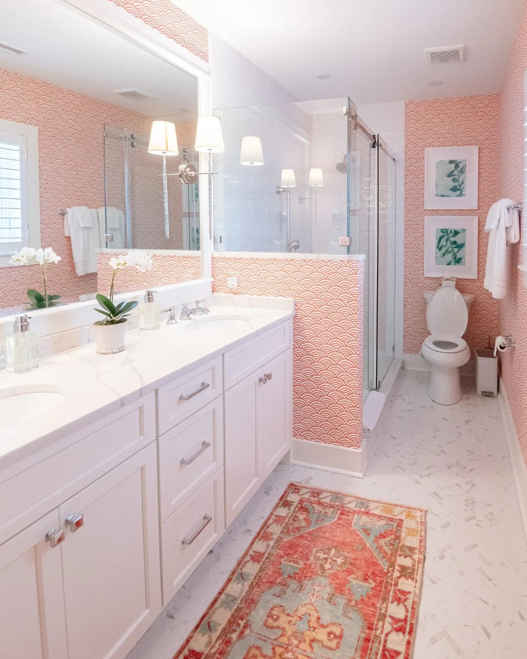 The color palette in this bathroom hits such a beautiful balance. The pattern and color feel lively, while the white cabinetry with the herringbone floor keeps the whole space fresh and light.⁠
⁠
#interiordesign #bathroominspo #designinspo #wallpaper