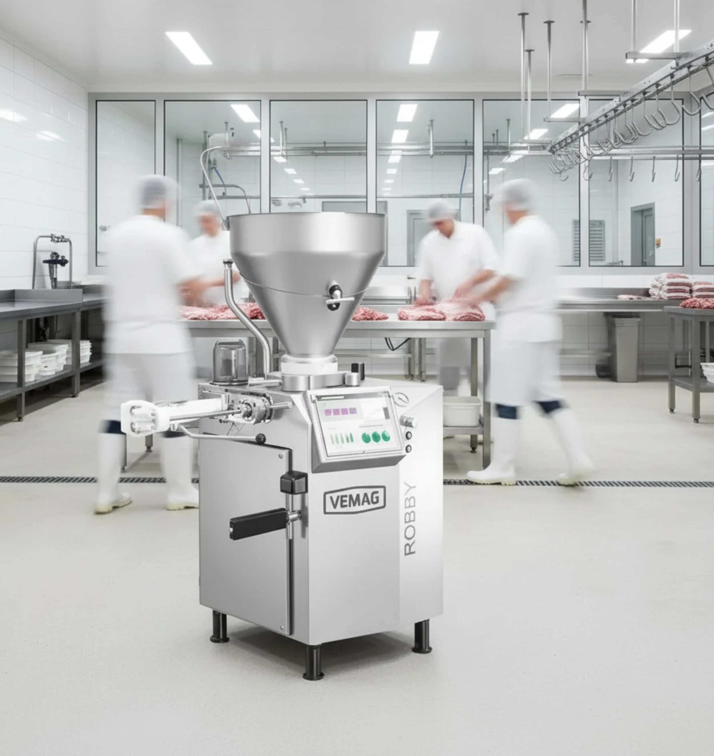 Vemag Mitarbeiter in weißen Schutzkleidung verarbeiten Fleisch in einer industriellen Metzgerei, im Vordergrund eine Fleischveredelungsmaschine.