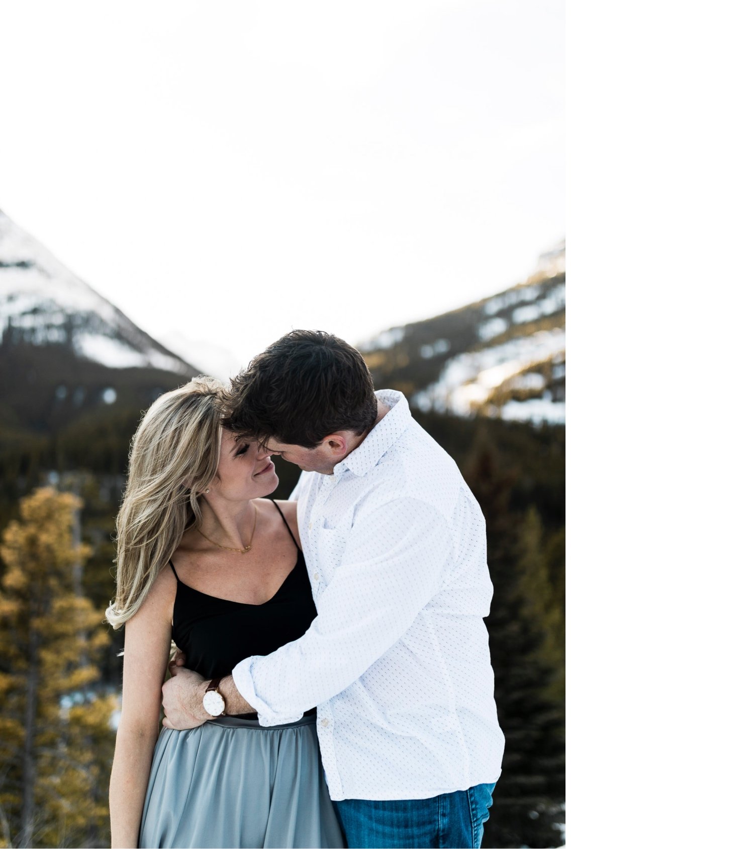 22_sunlight_landscape_Kananaskis_Canmore_Banff_trees_couple_engagement_close_simple_dog_cuddle_kiss_golden_hour_intimate_nature_mountains_fiancee_spring_winter_delicate_ice_bride_snow_soft_Calgary_Alberta_photographer_forest_groom_outdoor.jpg