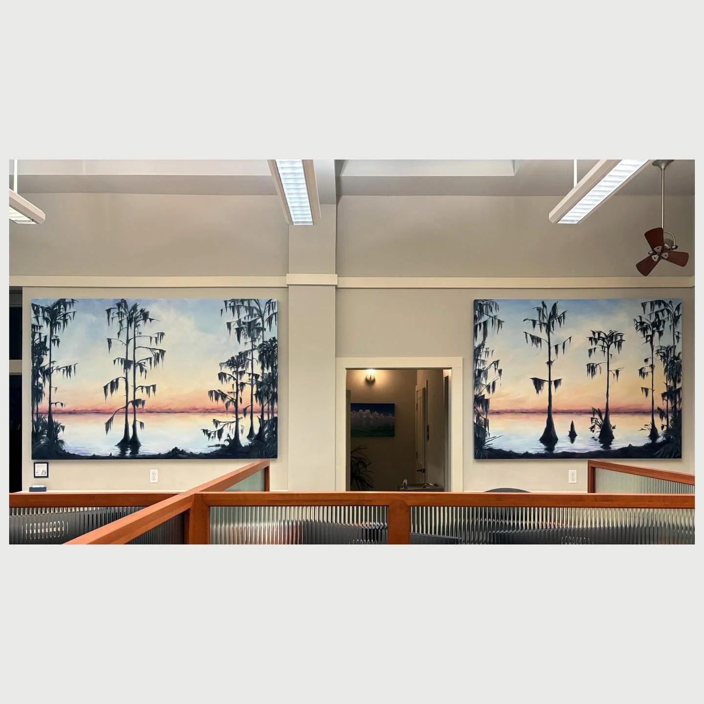 Take a closer look at this recently installed piece, a diptych (aka pair of paintings intended to appear side-by-side) picturing a winter sunset at Newnans Lake, originally known as Lake Pithlachocco, as seen from Lake Shore Drive in Gainesville. Oil