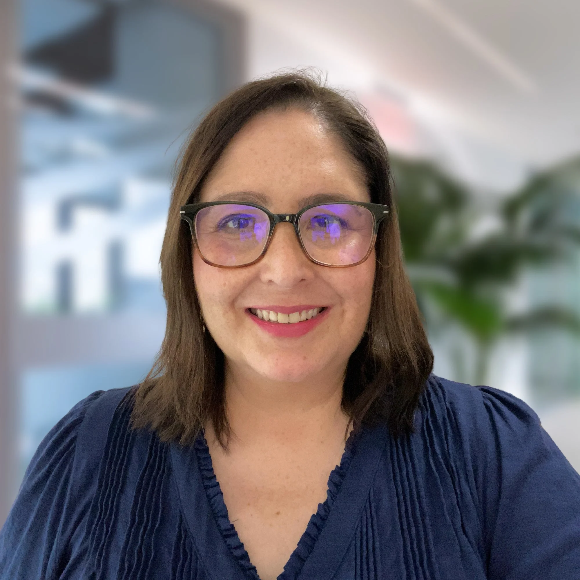 marissa barranco child counselor for separation anxiety is smiling in a office with plants in the background