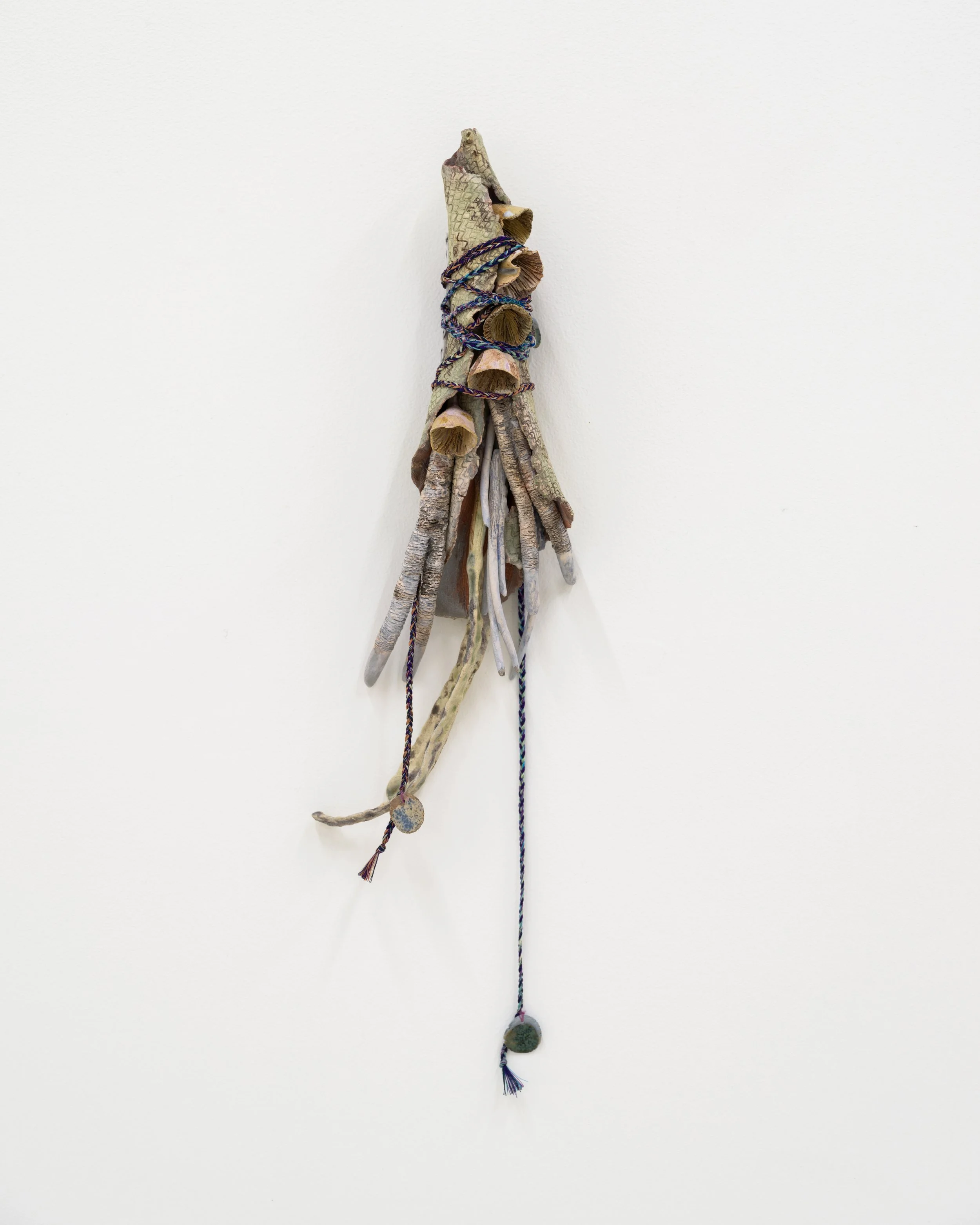 Untitled 1, 2023. Glazed ceramic, yarn, transparent paper, paper, graphite, charcoal, watercolor, muslin, hand dyed fabric, hand made cords, 17 x 4 x 1 3/4 in (43.18 x 10.16 x 4.445 cm)
