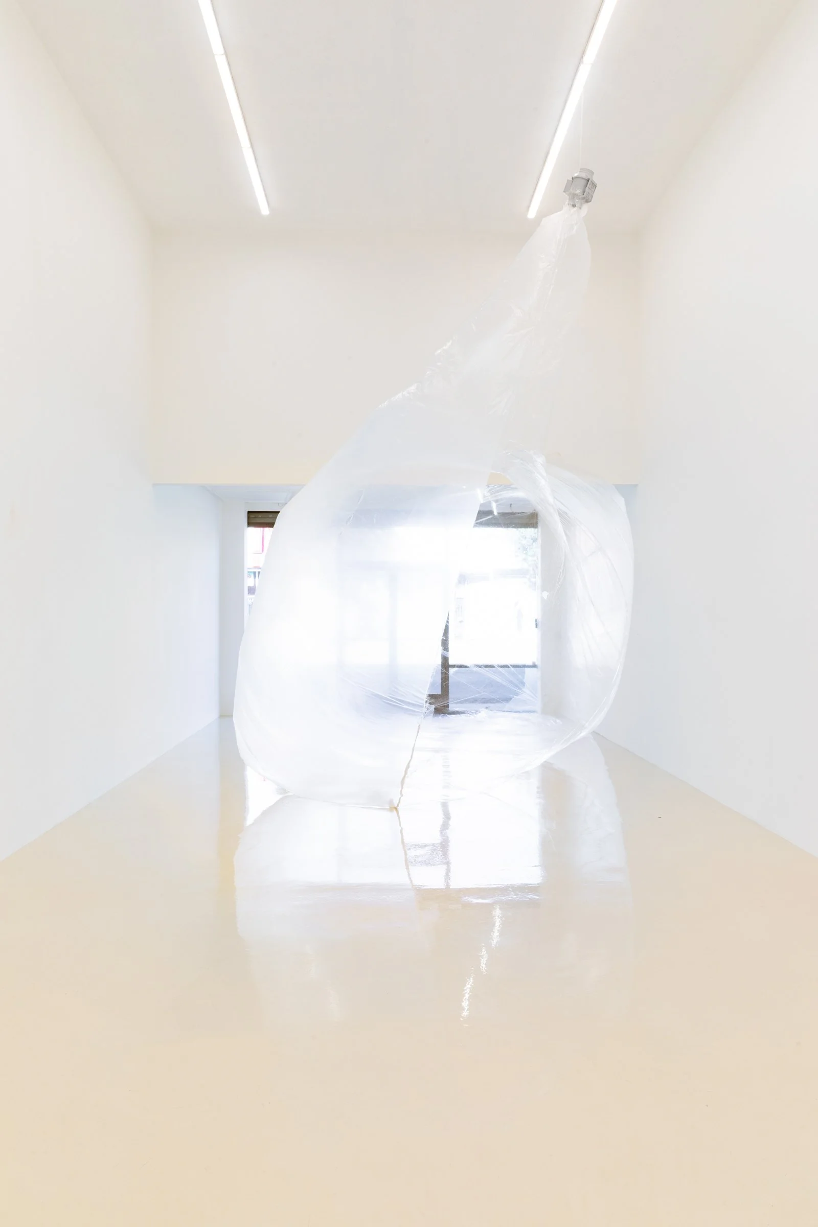 health house, inflatable, 2025. Cellophane, polythene, silver leaf and fan. Dimensions variable