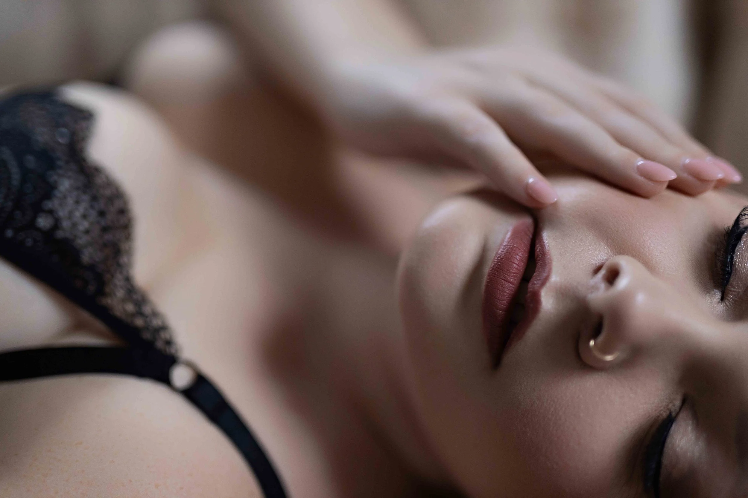 Boudoir Close up photo of a boudoir touching her red lips. NJ Boudoir photographer Cate Scagliione Life as Fine Art Rumson NJ. Boudoir Photographer Near Me