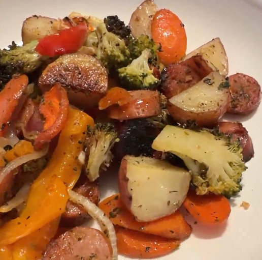 Cooked roasted vegetables including broccoli, carrots, potatoes, and bell peppers.