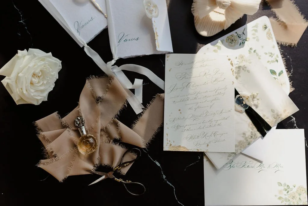 Luxury custom wedding invitations with gold foil and calligraphy. High-end wedding stationery design featuring deckled edges and wax seals.