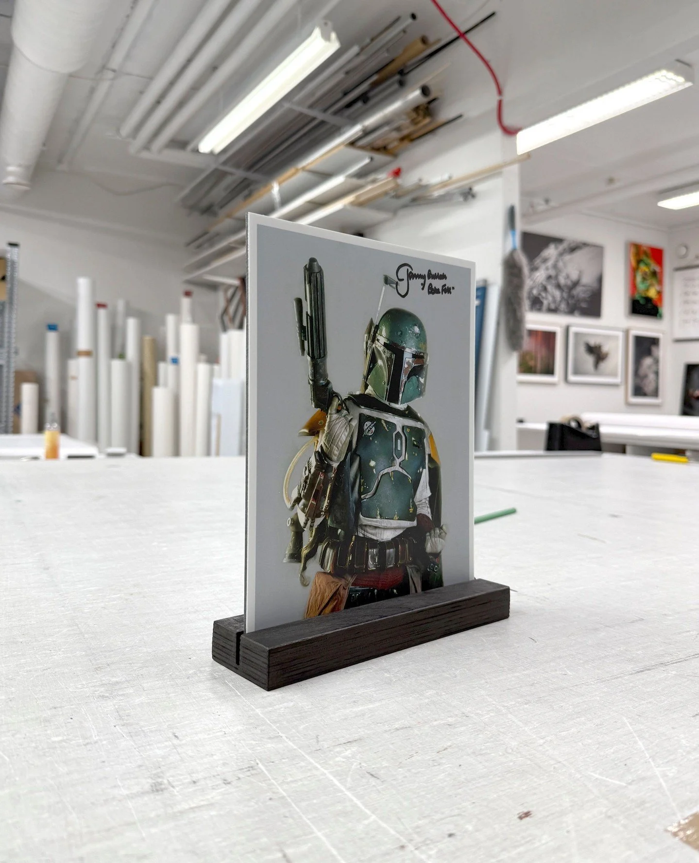 A special piece for a client who wanted a proper stand and support for a cherished photograph &mdash; featuring a signed portrait of Jimmy Bulloch, also known as Boba Fett.⁠
⁠
We crafted a custom black-stained plywood base paired with a 2 mm Dibond-m