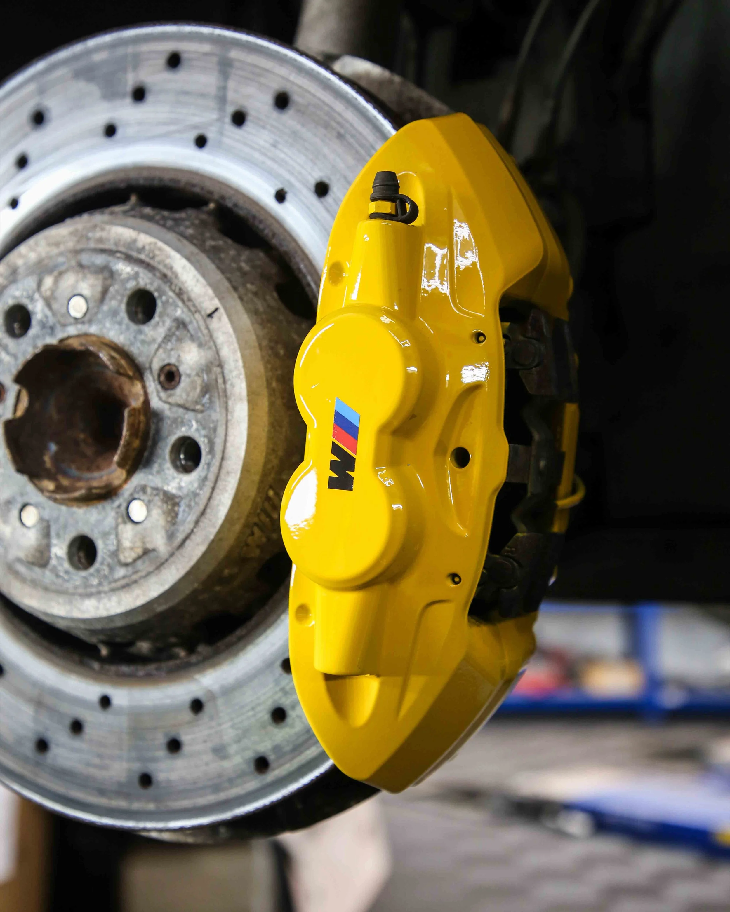 BMW M4 F82 brake calipers painted in gloss bright yellow
