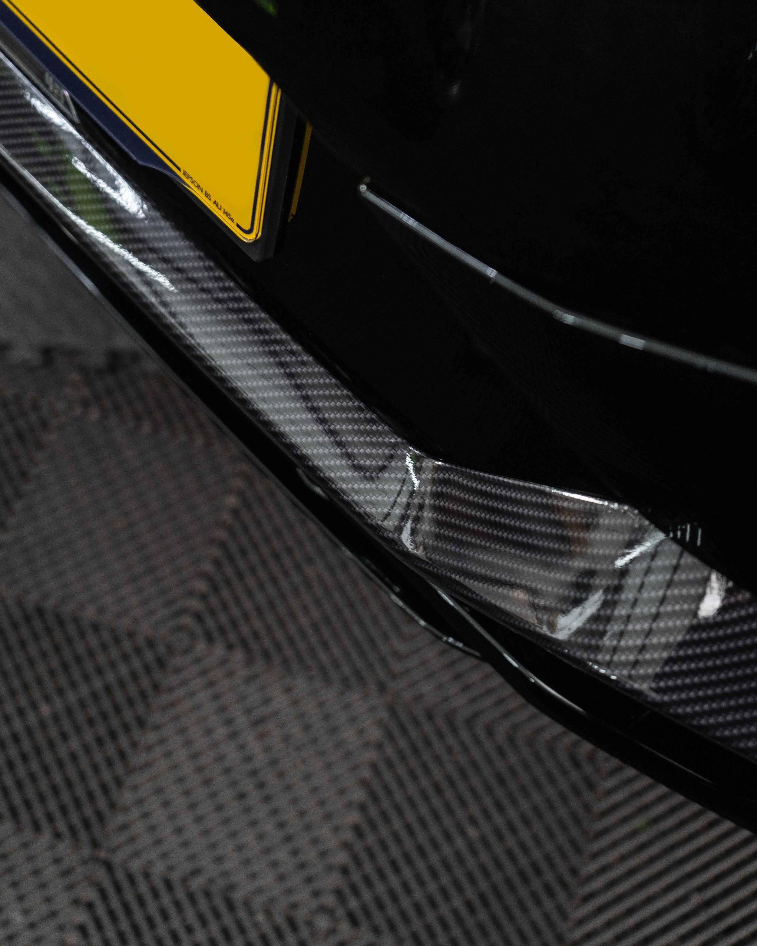 Lotus Eletre lower trims, spoiler, wing mirrors and bonnet wrapped in 3M Gloss Metallic Carbon Fibre wrapping film. Protected with a Ceramic coating.