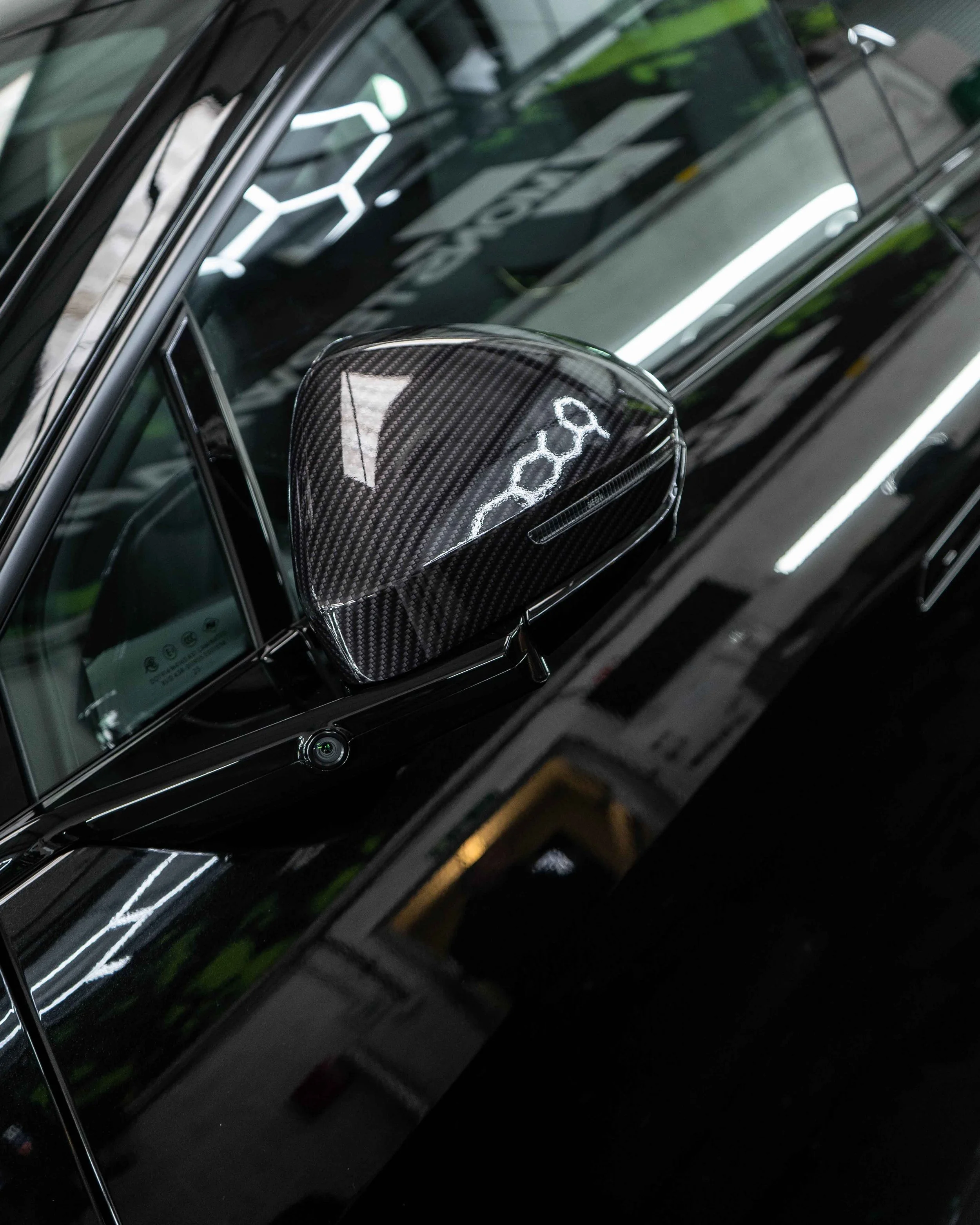 Lotus Eletre lower trims, spoiler, wing mirrors and bonnet wrapped in 3M Gloss Metallic Carbon Fibre wrapping film. Protected with a Ceramic coating.