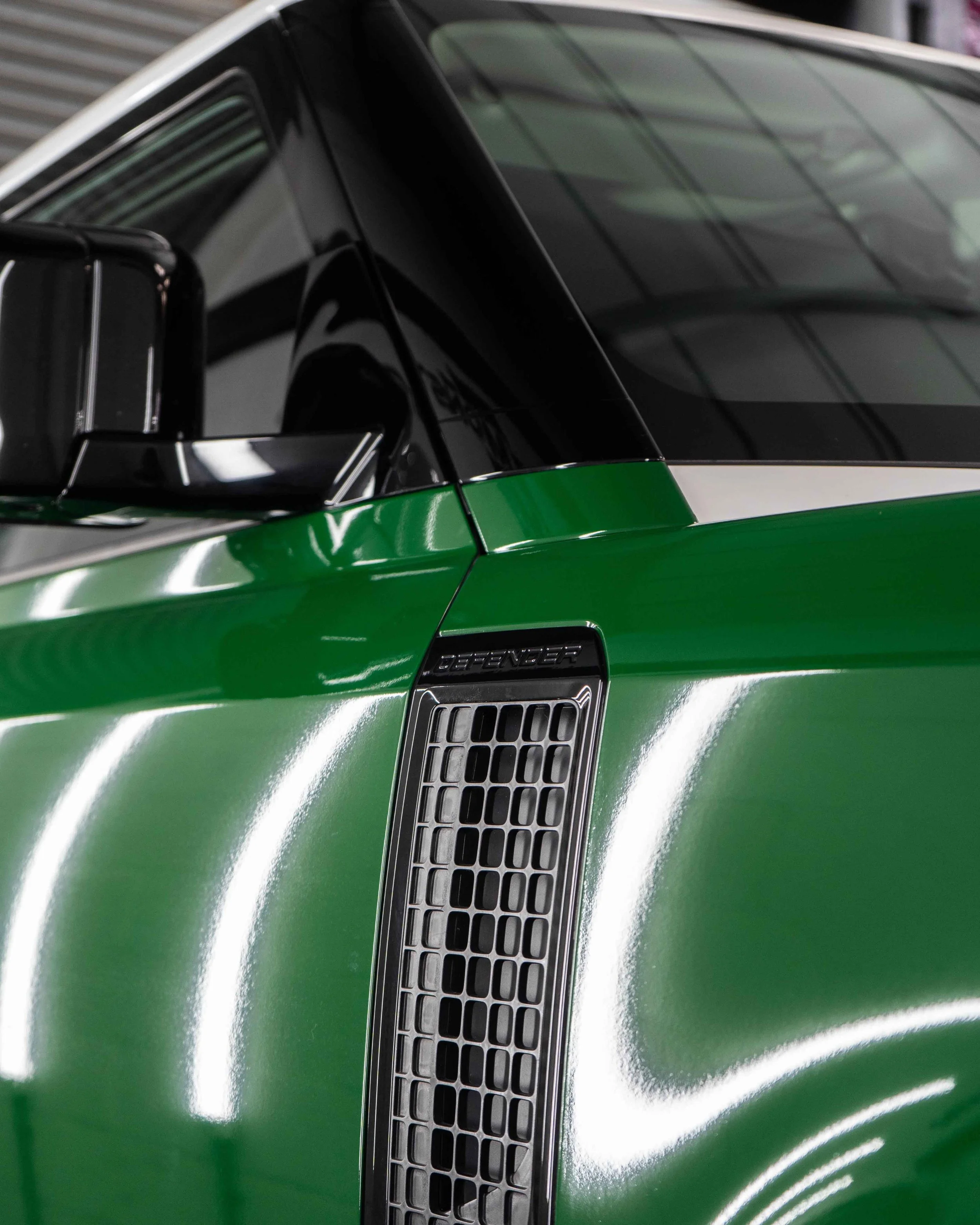 Land Rover Defender 90 full colour change vinyl wrap in Gloss Dark Green