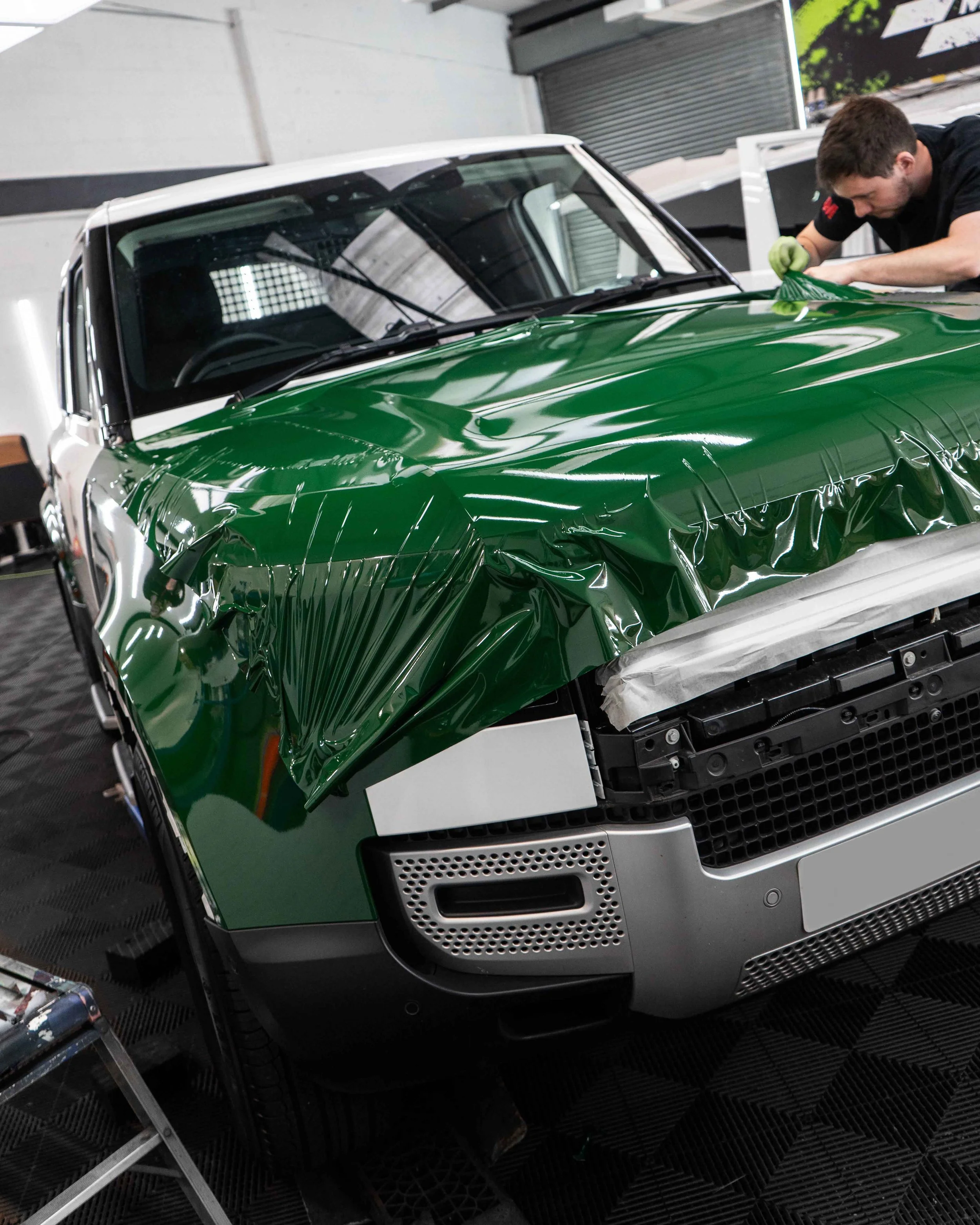 Land Rover Defender 90 full colour change vinyl wrap in Gloss Dark Green