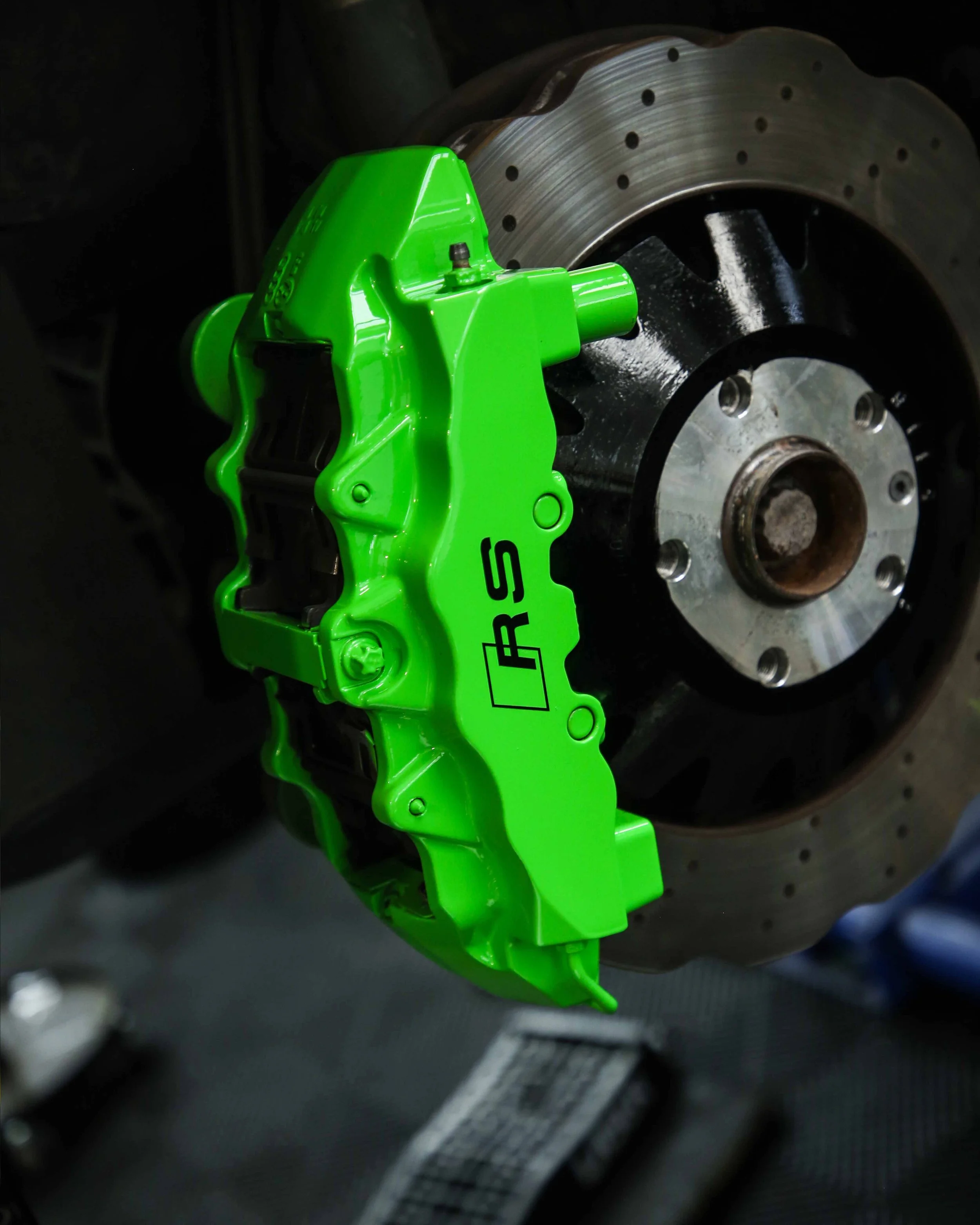 audi rs3 brake calipers painted in gloss bright green with gloss black hubs