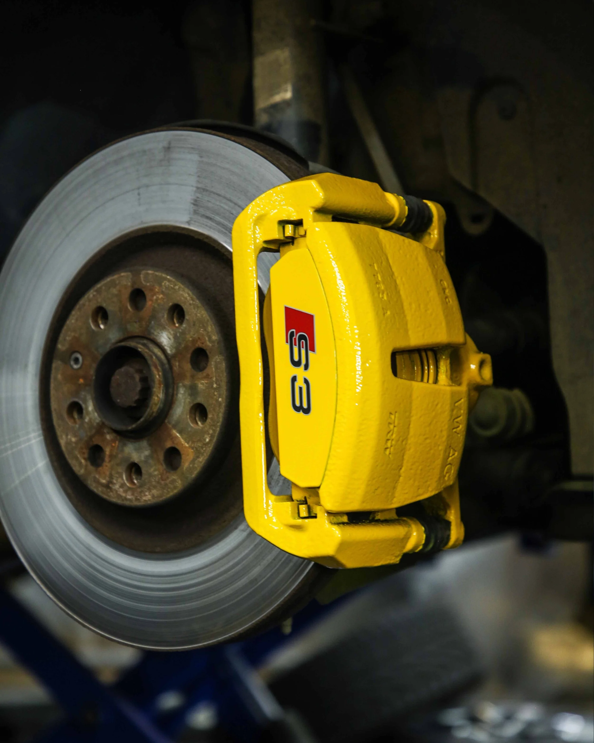 audi s3 brake calipers painted in gloss bright yellow