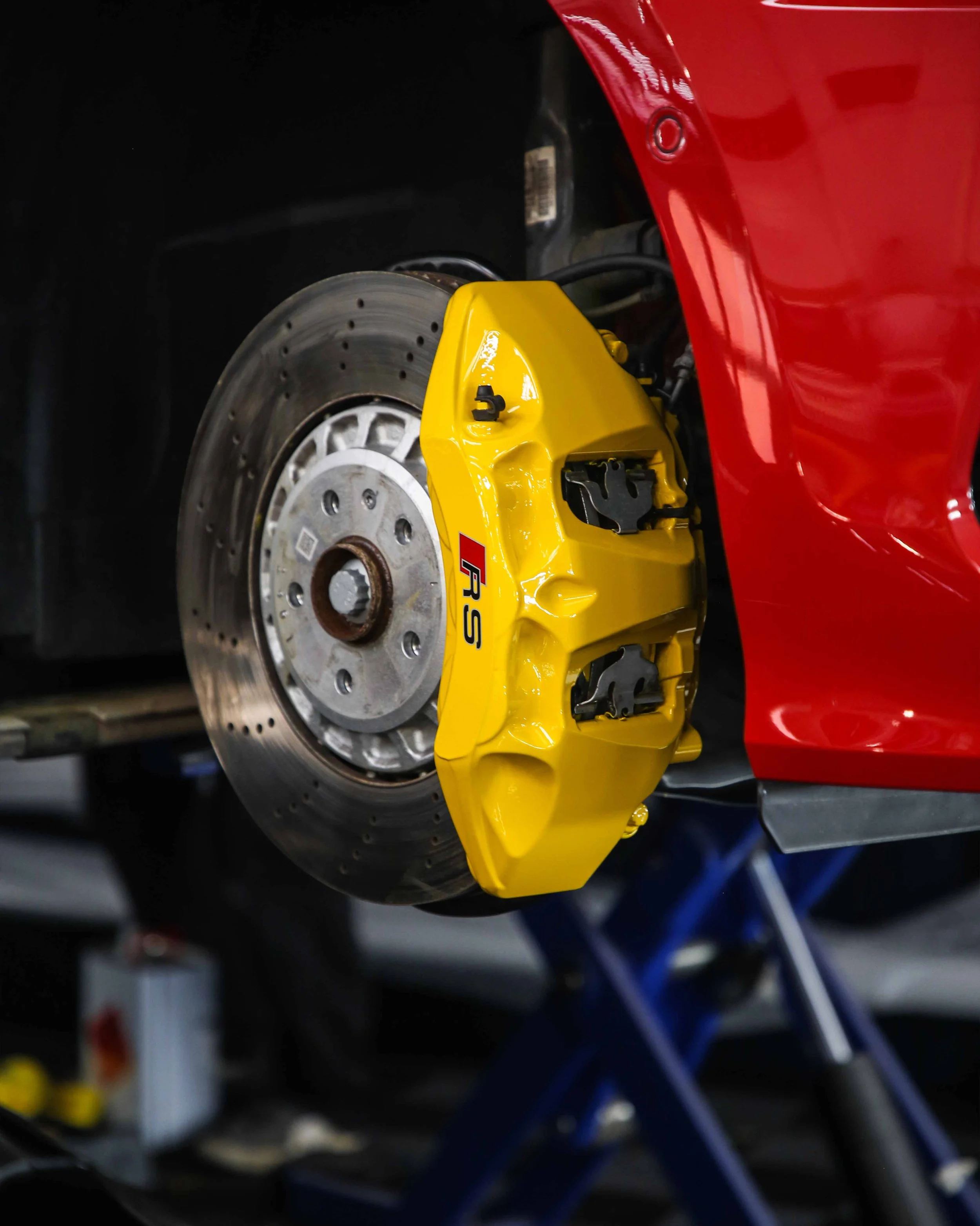 audi rs3 brake calipers painted in gloss bright yellow