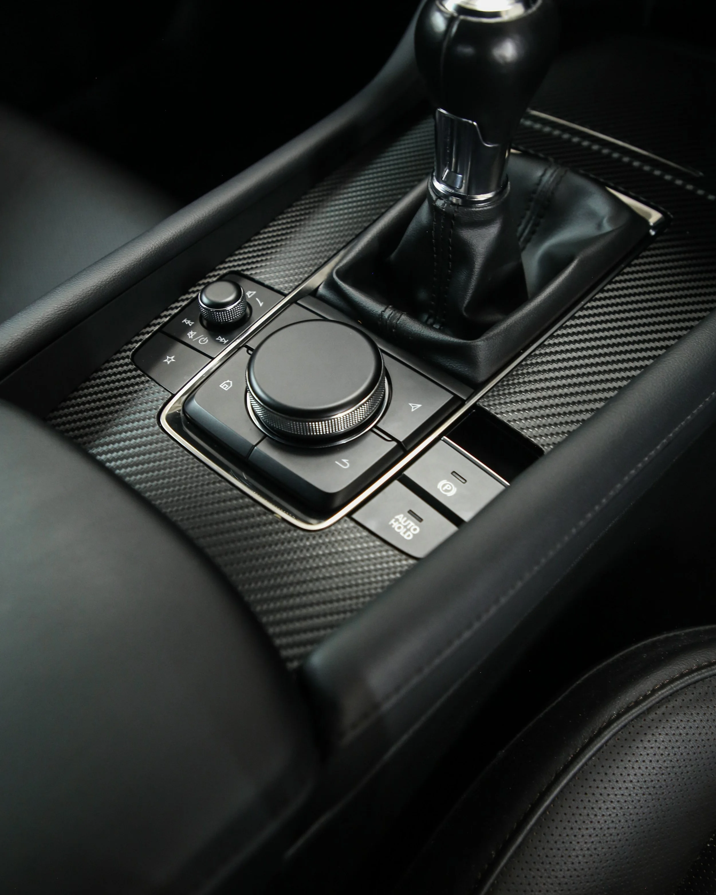 Mazda 3 interior trim, centre console wrapped in 3M Black Textured Carbon Fibre by Monsterwraps Southampton