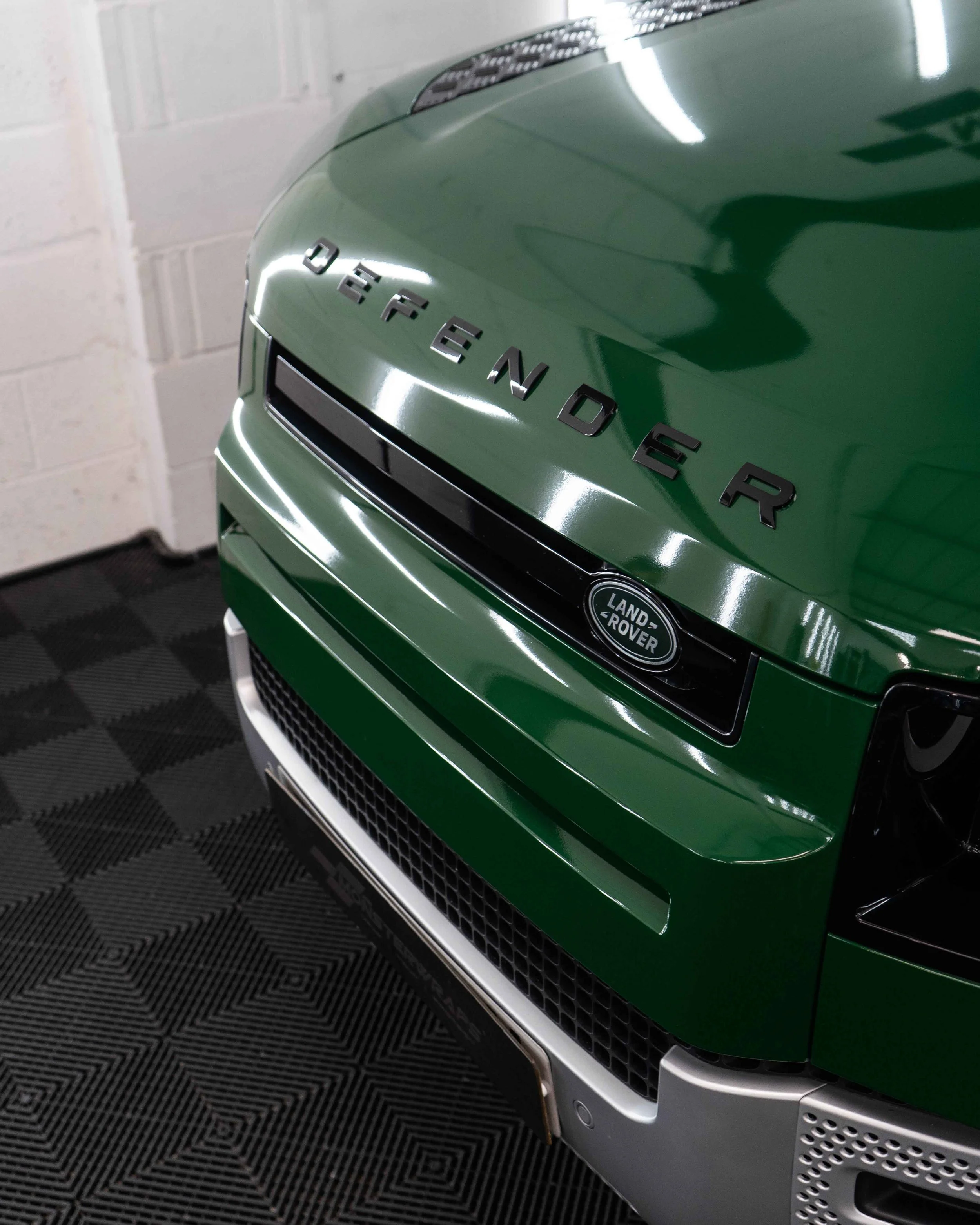 Land Rover Defender 90 full colour change vinyl wrap in Gloss Dark Green