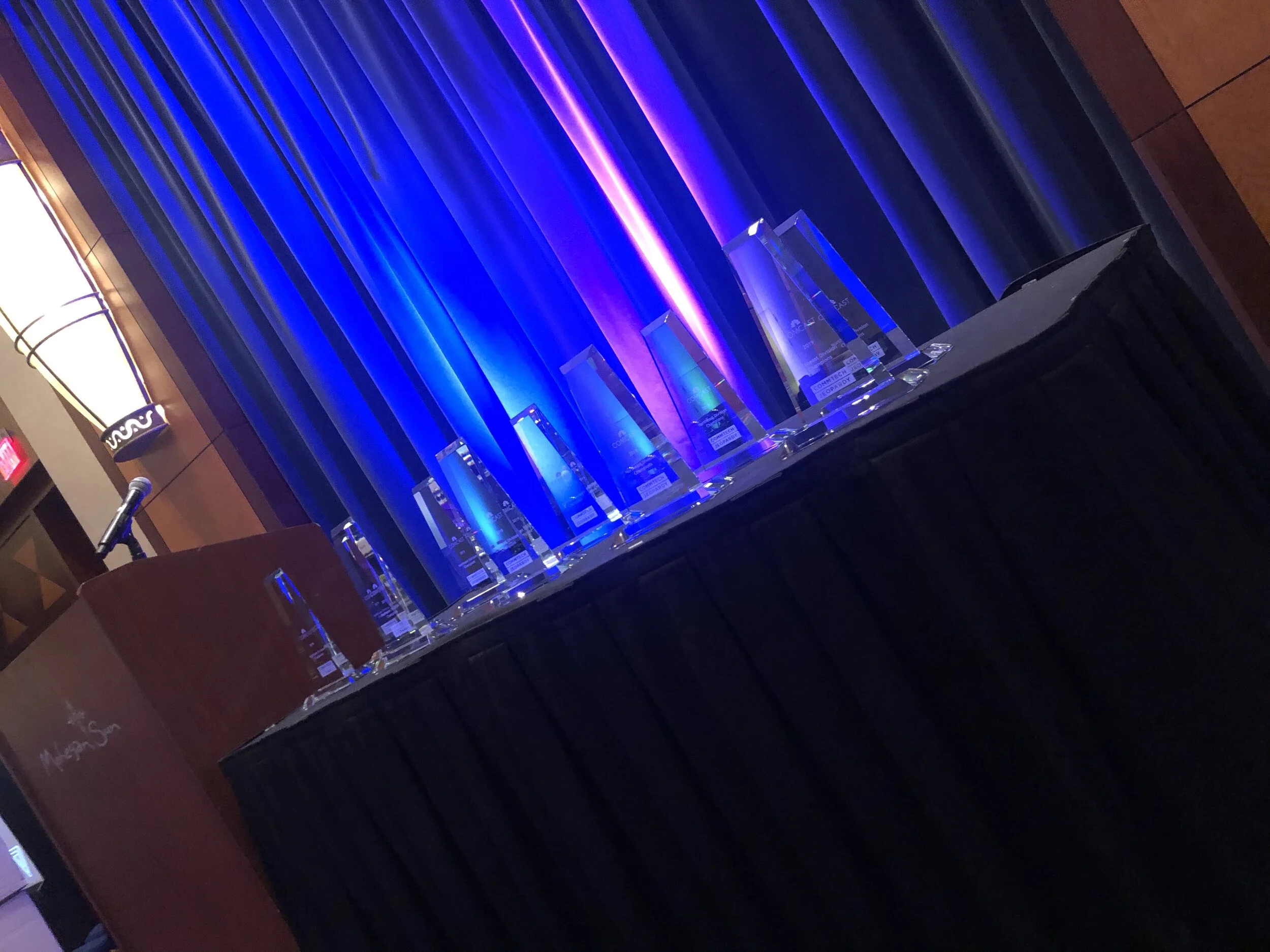 table with crystal awards uplit with blue lighting