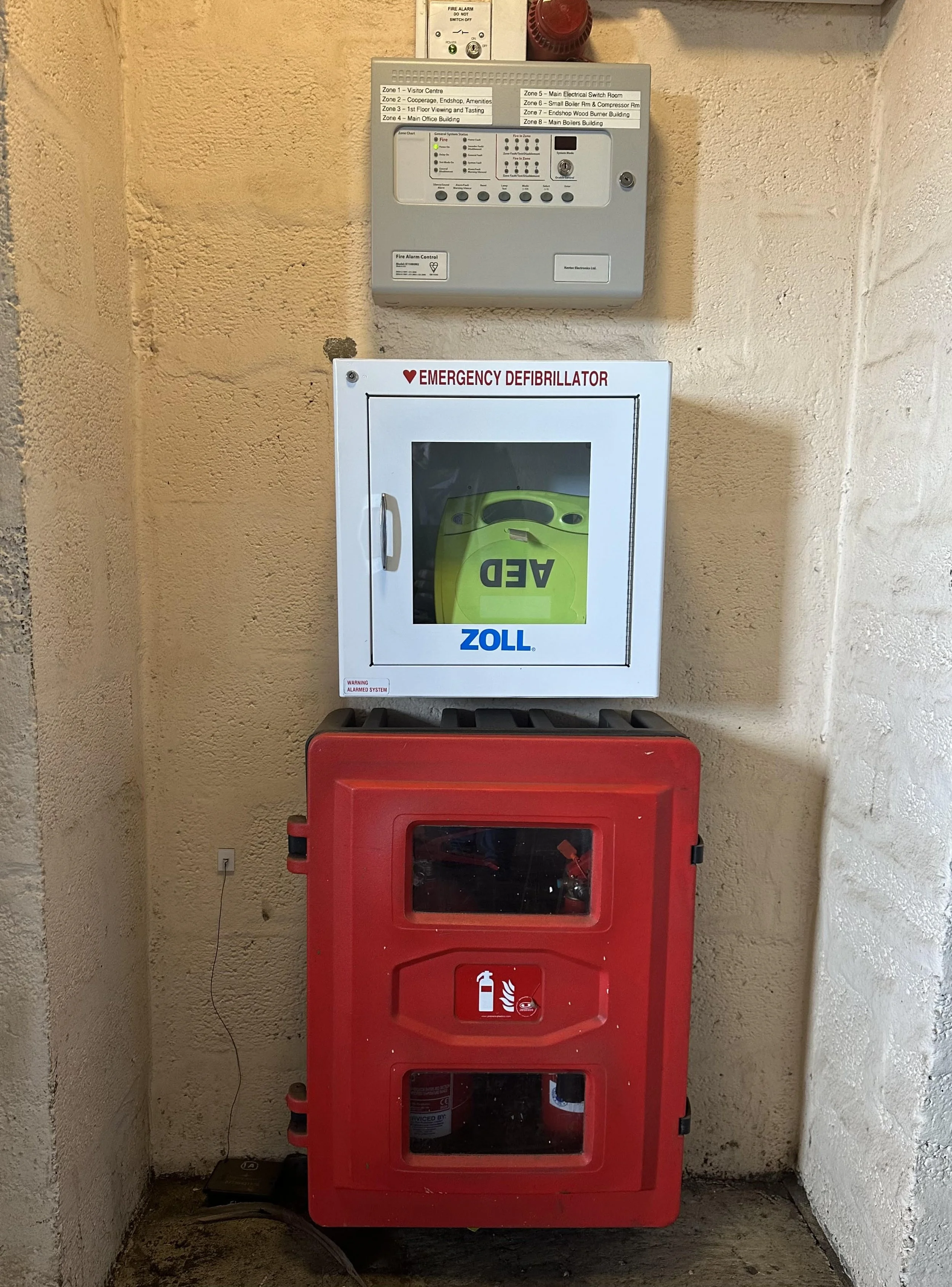 Fire alarm, defib unit and fire extinguishers.