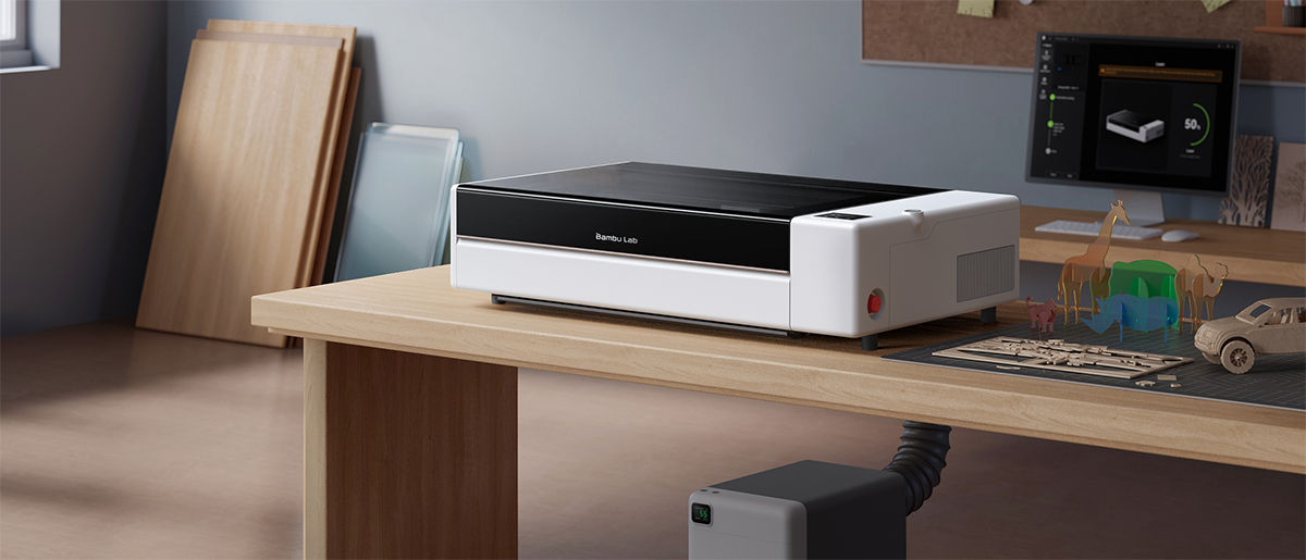 R1 Co2 Laser cutter on a table with plenty of material around it