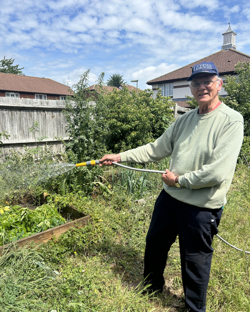 John watering the veg patch