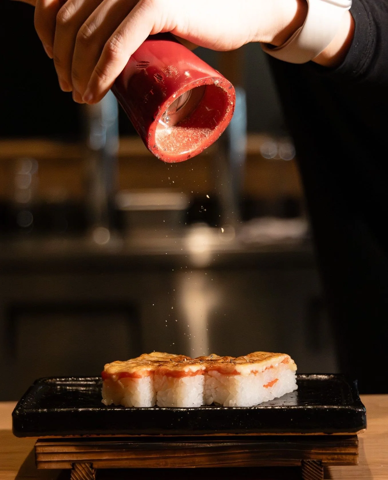 Ooooooshi! We start with layers of salmon or ebi and seasoned Hello Nori rice, pressed into perfect rectangles. ⁠
⁠
Then comes the transformation.⁠
⁠
We charcoal torch the oshis, searing the fat and caramelizing our signature sauce. In seconds, the t