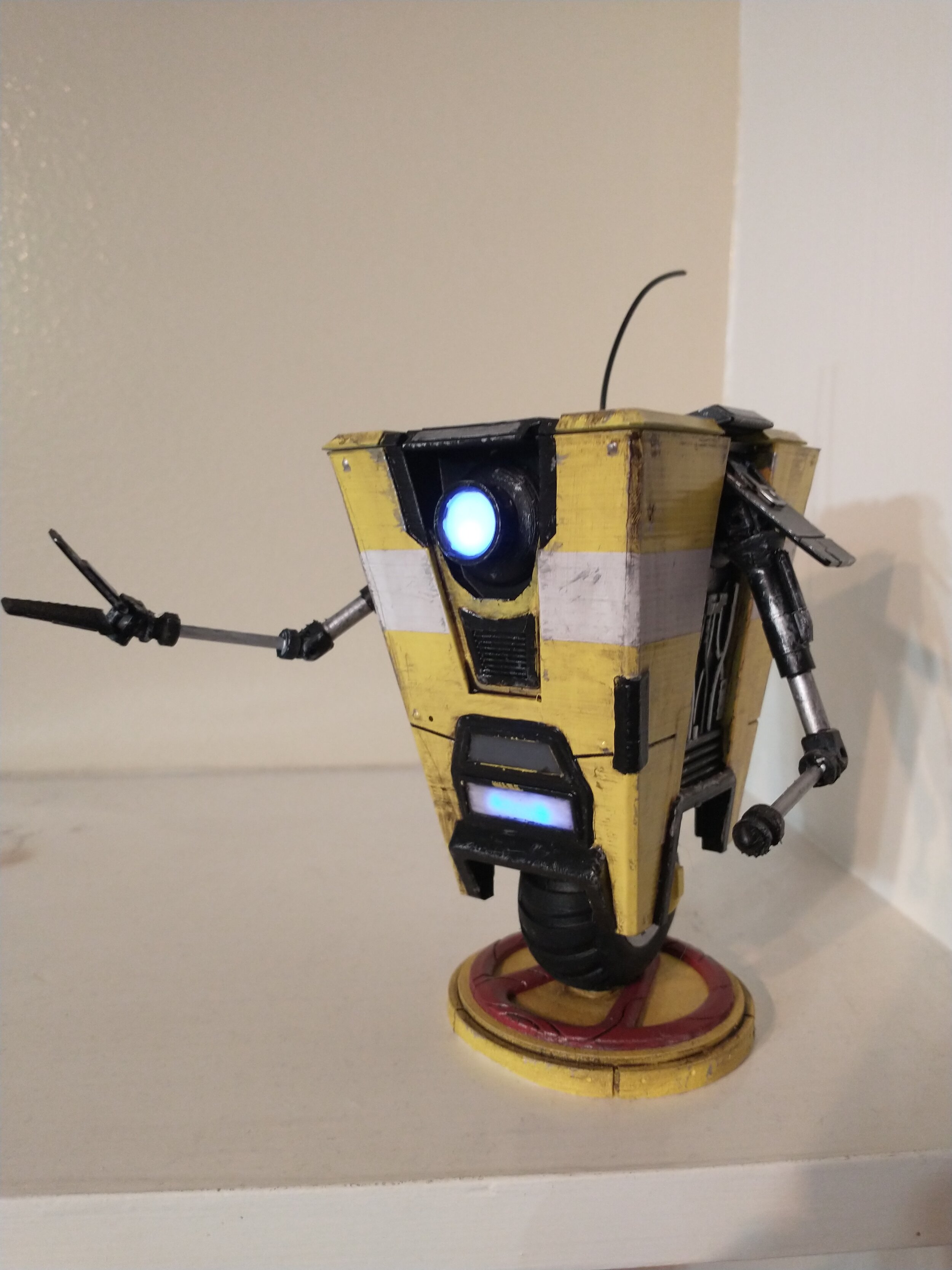 Claptrap from the game Borderlands 2. This consists of 4 LED's and a 9V battery housed within the body. This was painted and weathered the same way the Ace of Spades was.