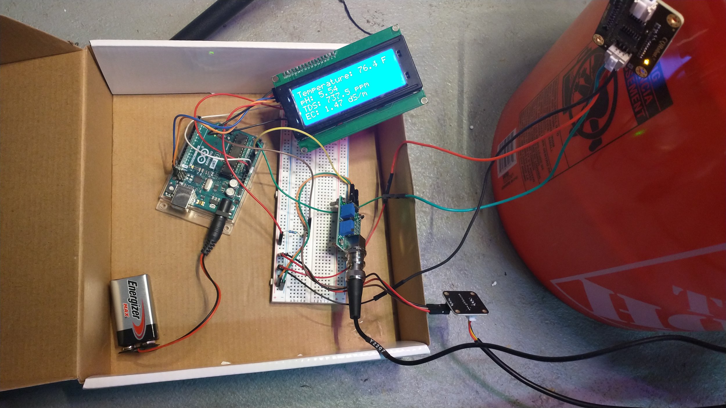 The exposed Arduino system, including a nutrient concentration, pH, and temperature readout.