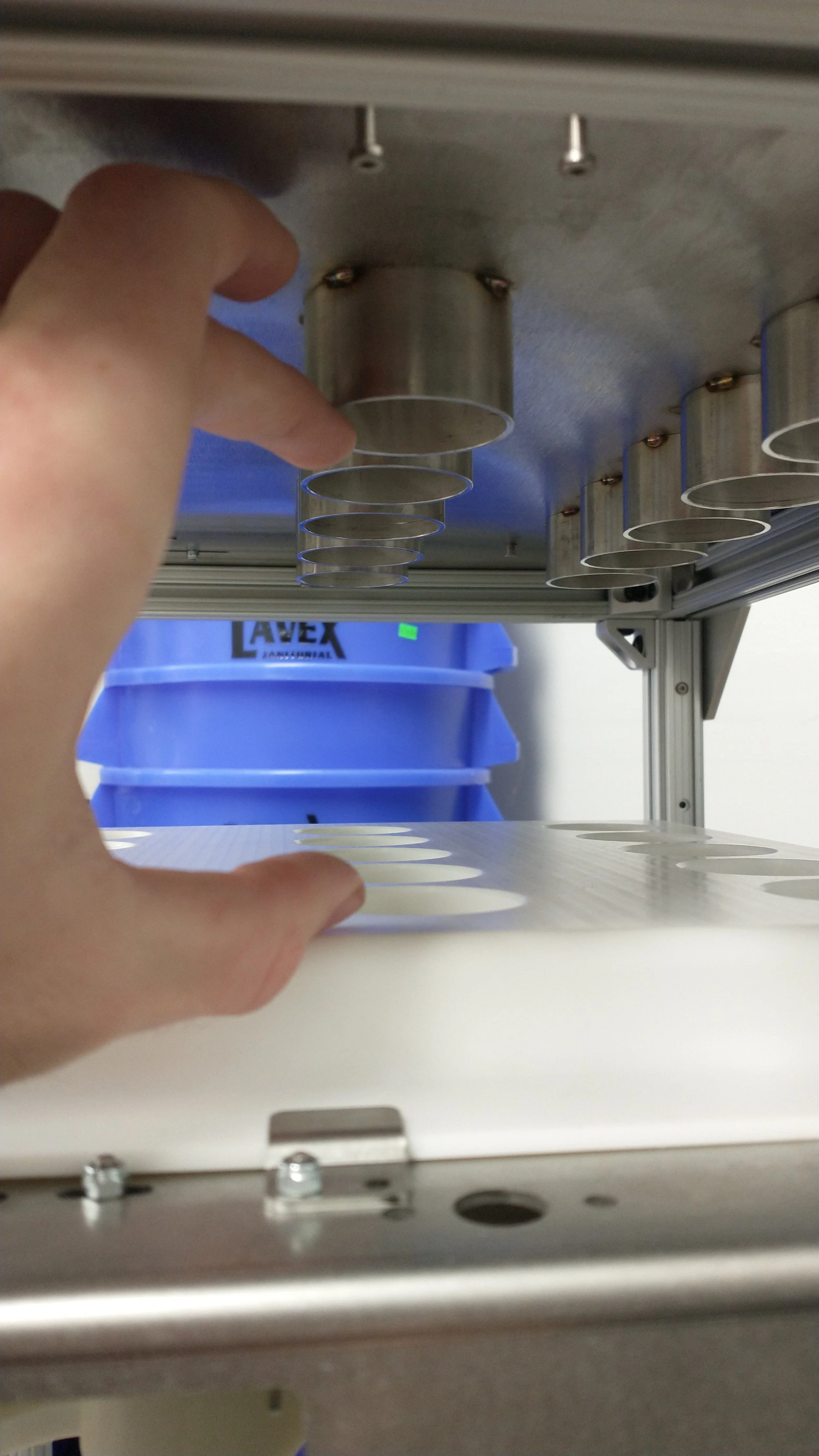 Shown here are the telescoping tubes that determine the amount of beans that go into each pod. A lead screw on each side (not show) determine the depth at which the metal tubes sit in the respective plastic part.