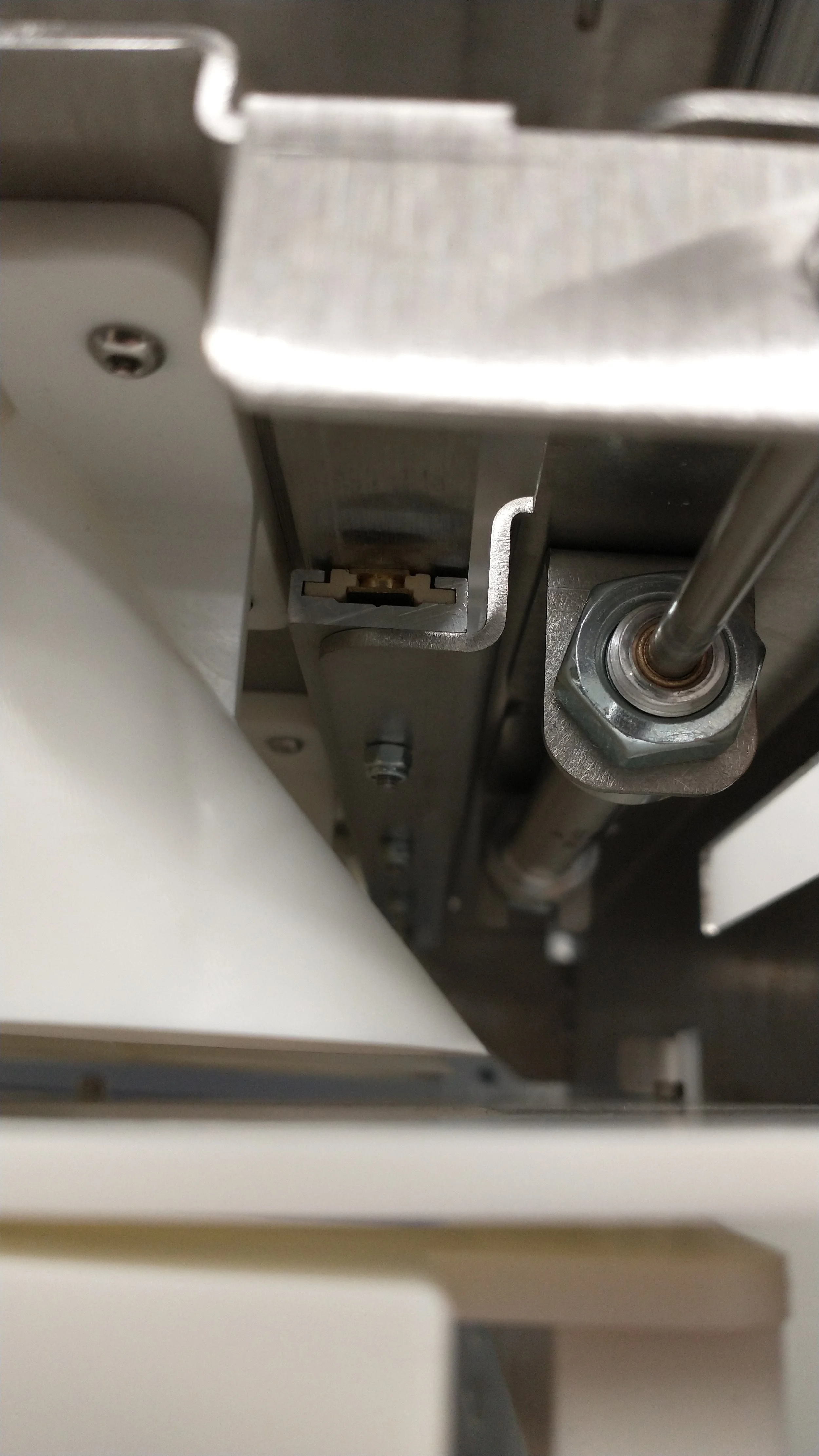 The pneumatic cylinders and linear bearings allow for smooth, automatic movement of the plates required to measure and release the beans.
