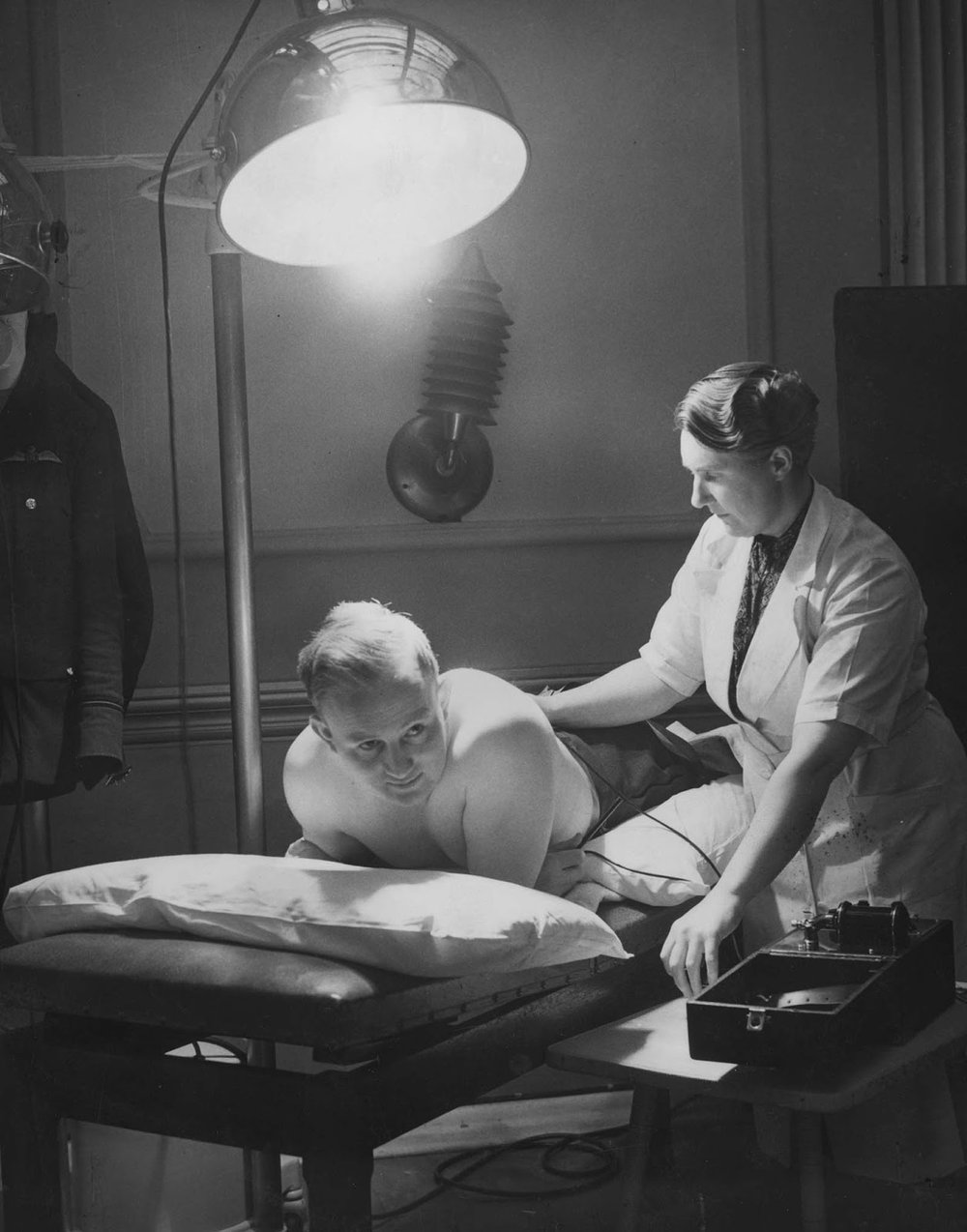  An RAF Flying Officer receiving Sun-Ray and electrical treatment after suffering a broken back. 1941. 