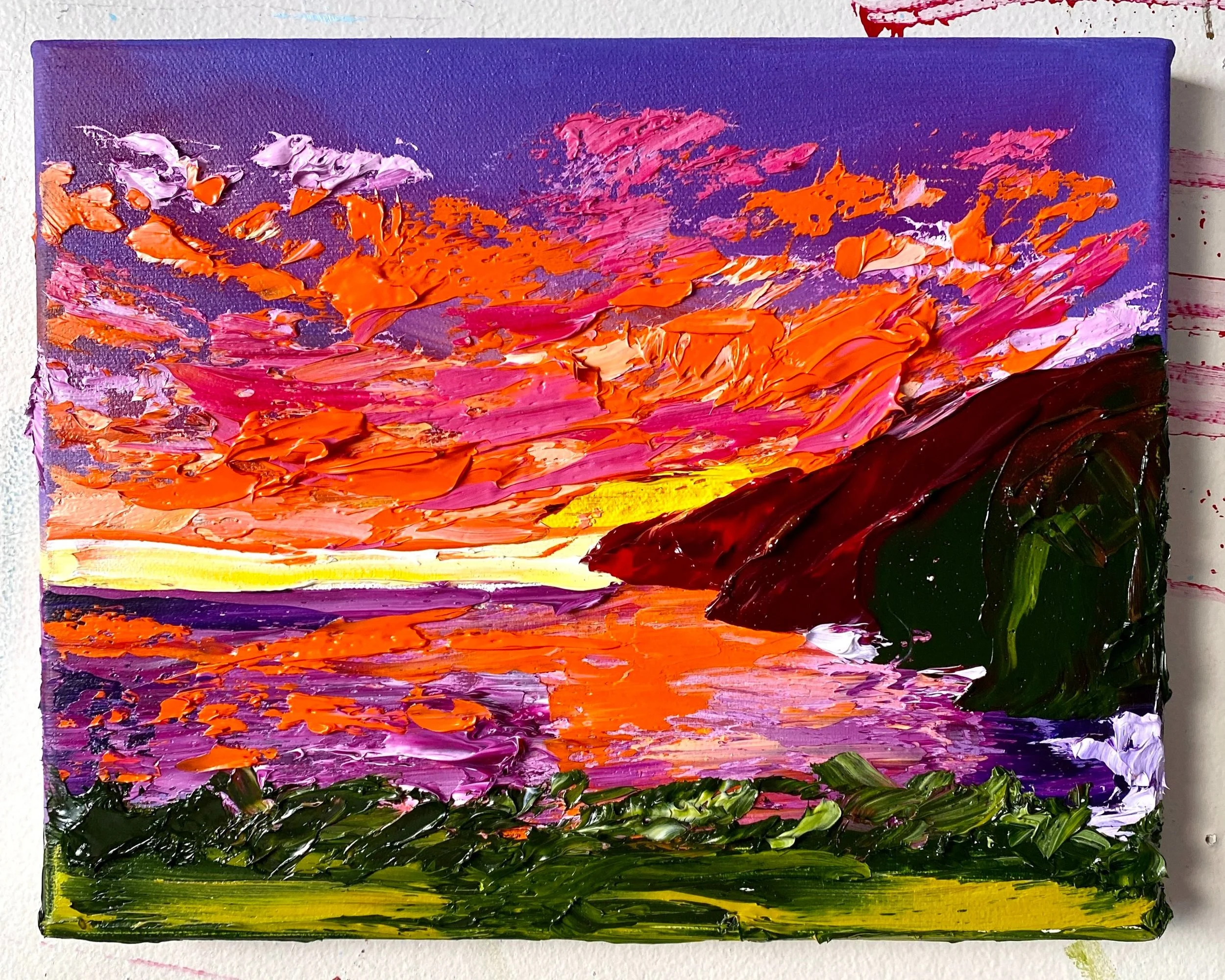 Abstract landscape painting with a colorful sky, a body of water reflecting the sky, and dark green hills on the right side.