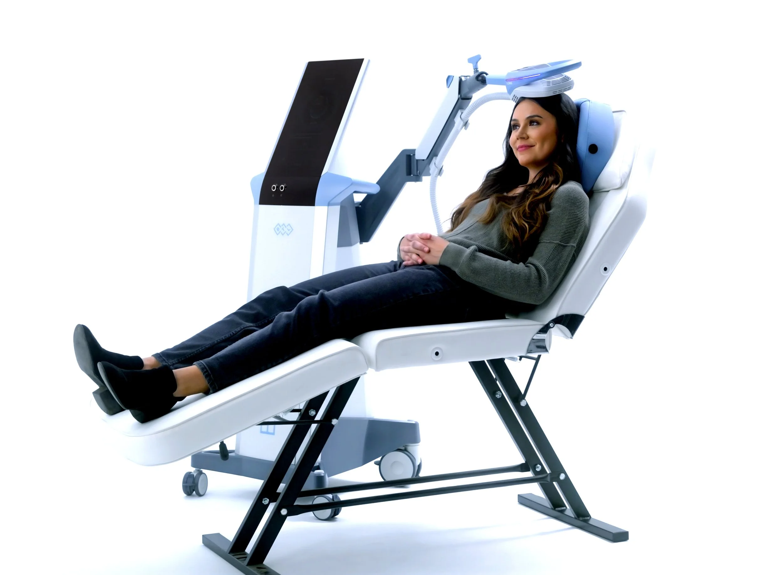 A woman lying on a futuristic medical or research bed connected to a high-tech machine.