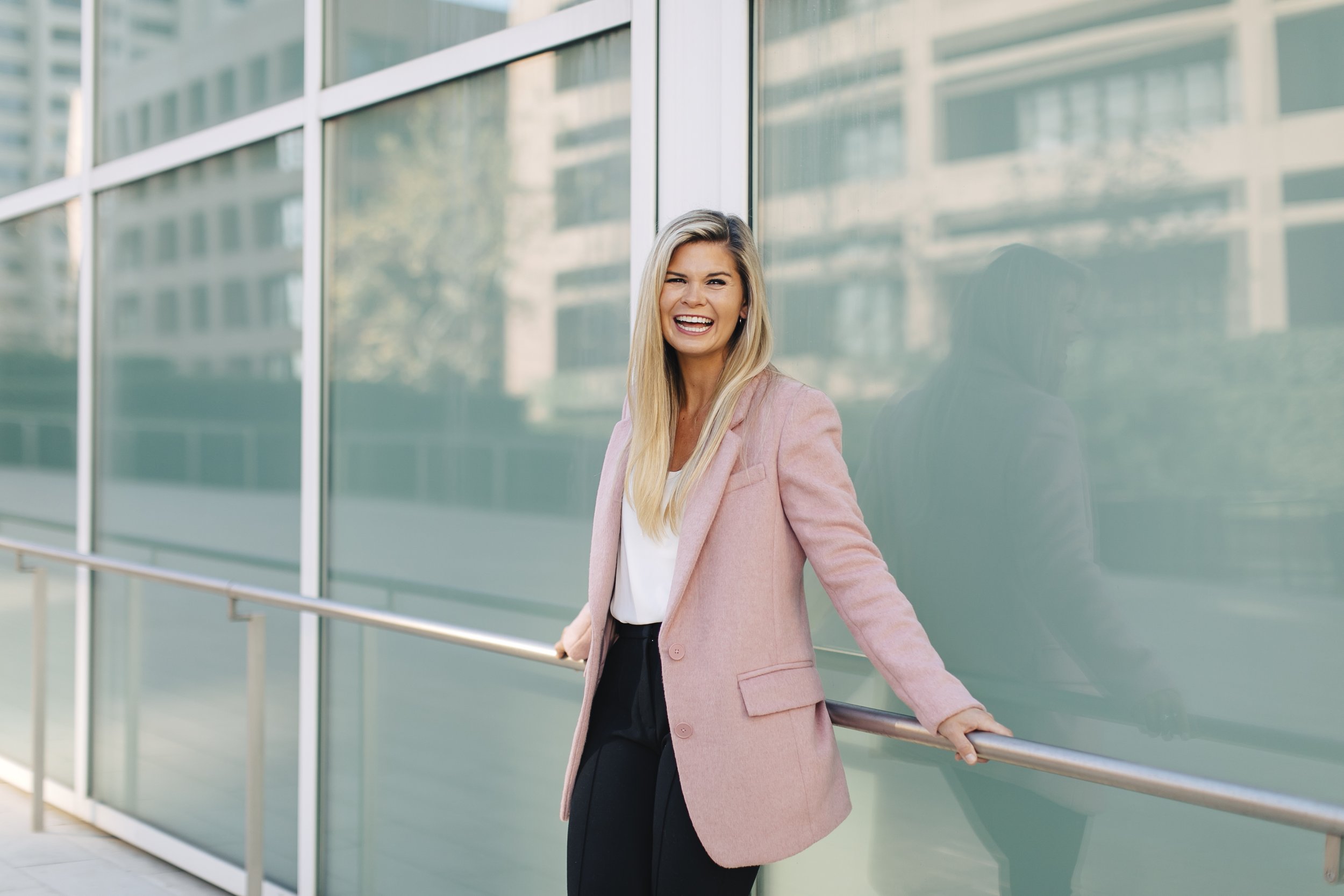 Career Coach for women, Kate Rosenberg, shown demonstrating executive presence near a corporate building in downtown San Diego
