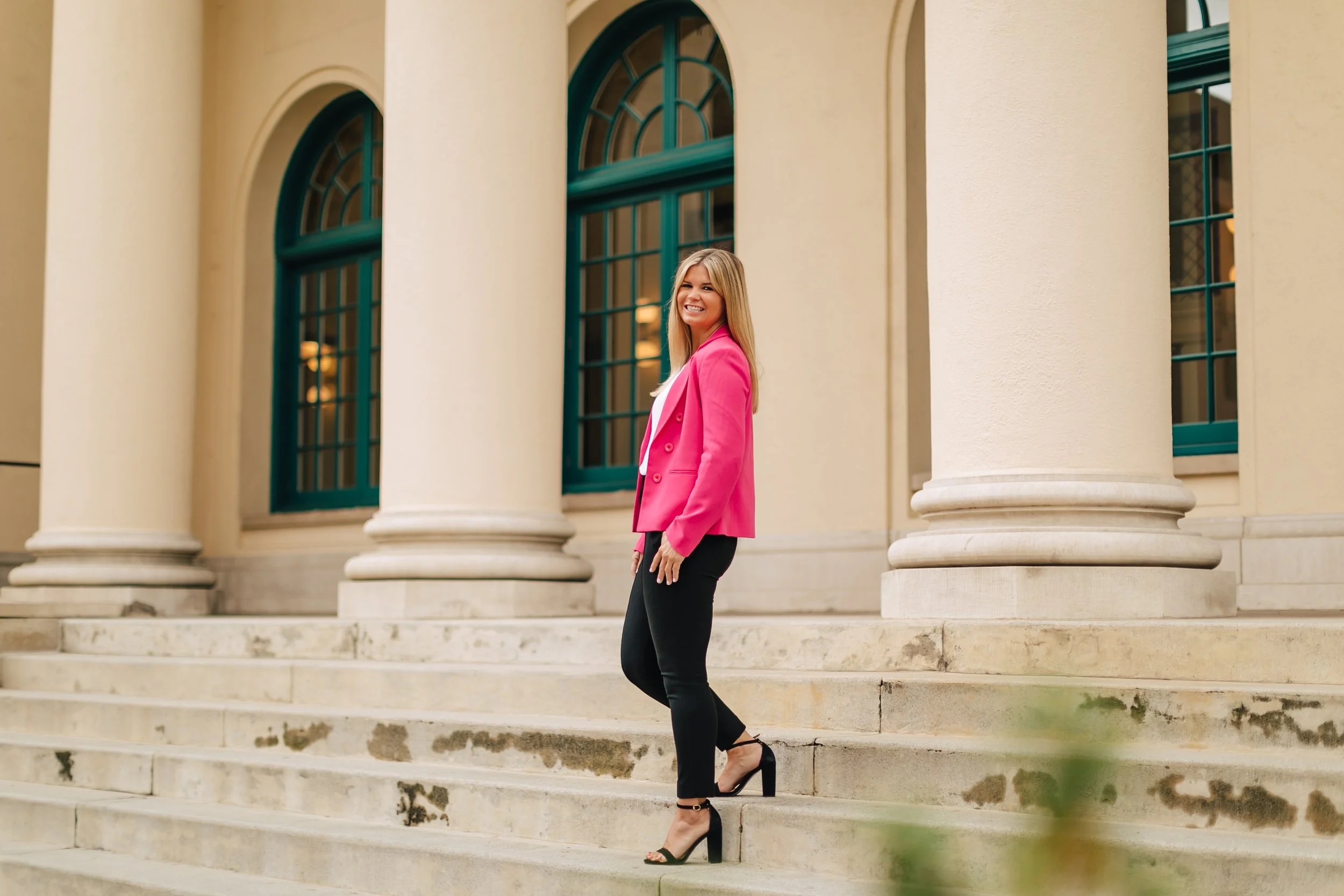 Career Coach Kate Rosenberg on the steps of a professional building in downtown San Diego